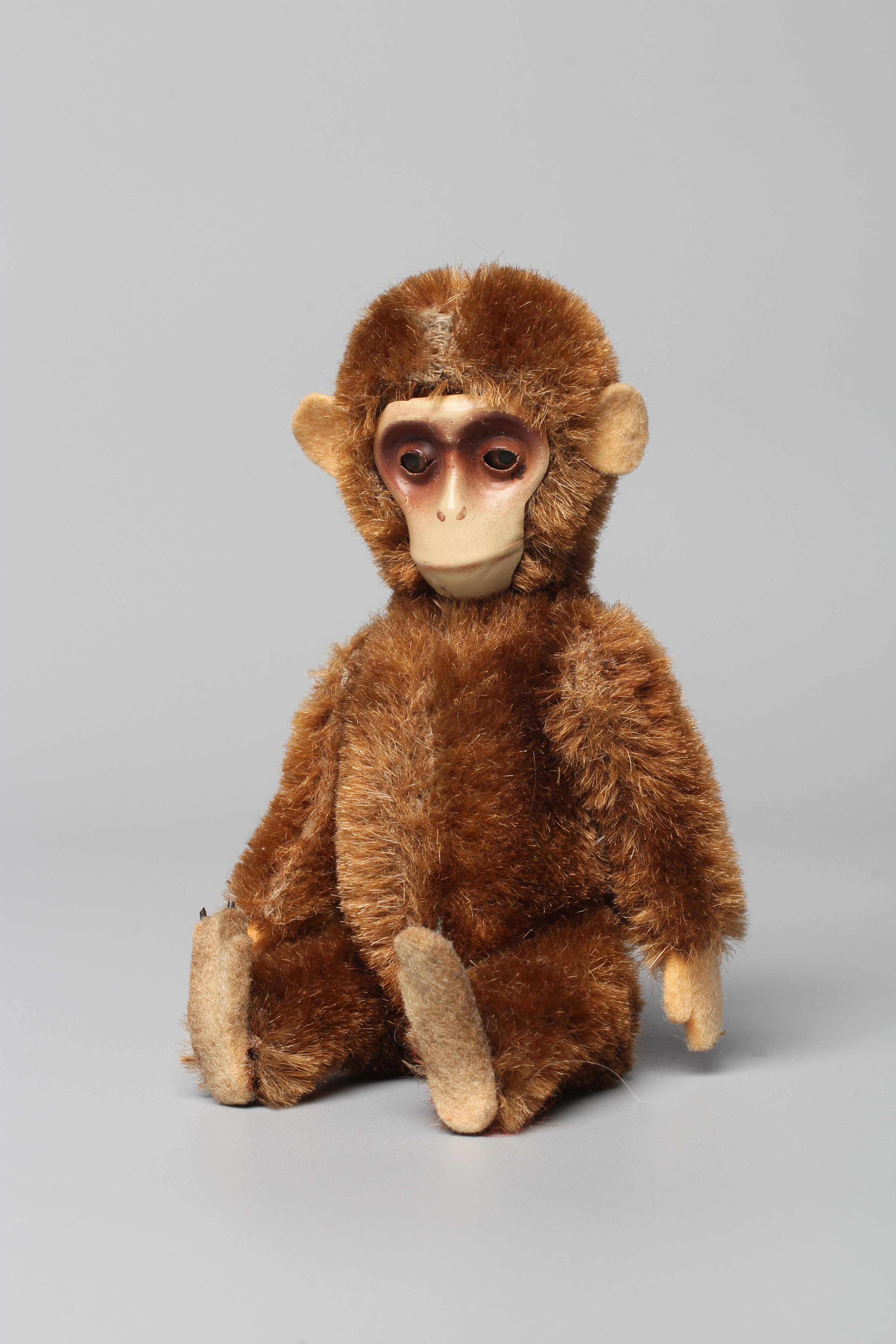 A Schuco yes/no monkey, with tin face, head shake mechanised via the tail, brown plush jointed body Image