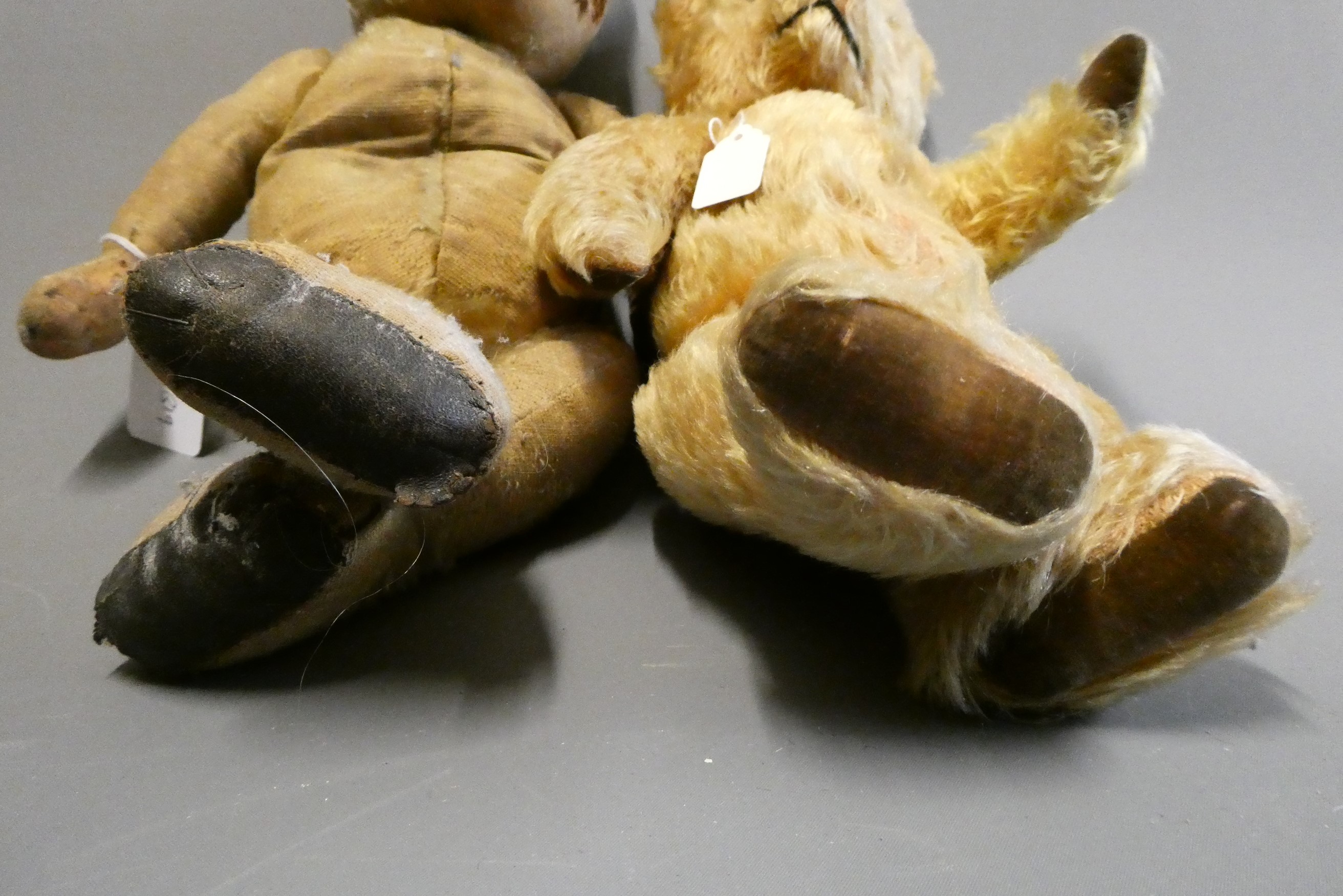 Two old teddy bears, including a 17" bear with amber glass eyes, leather pads and hump to back, and Image