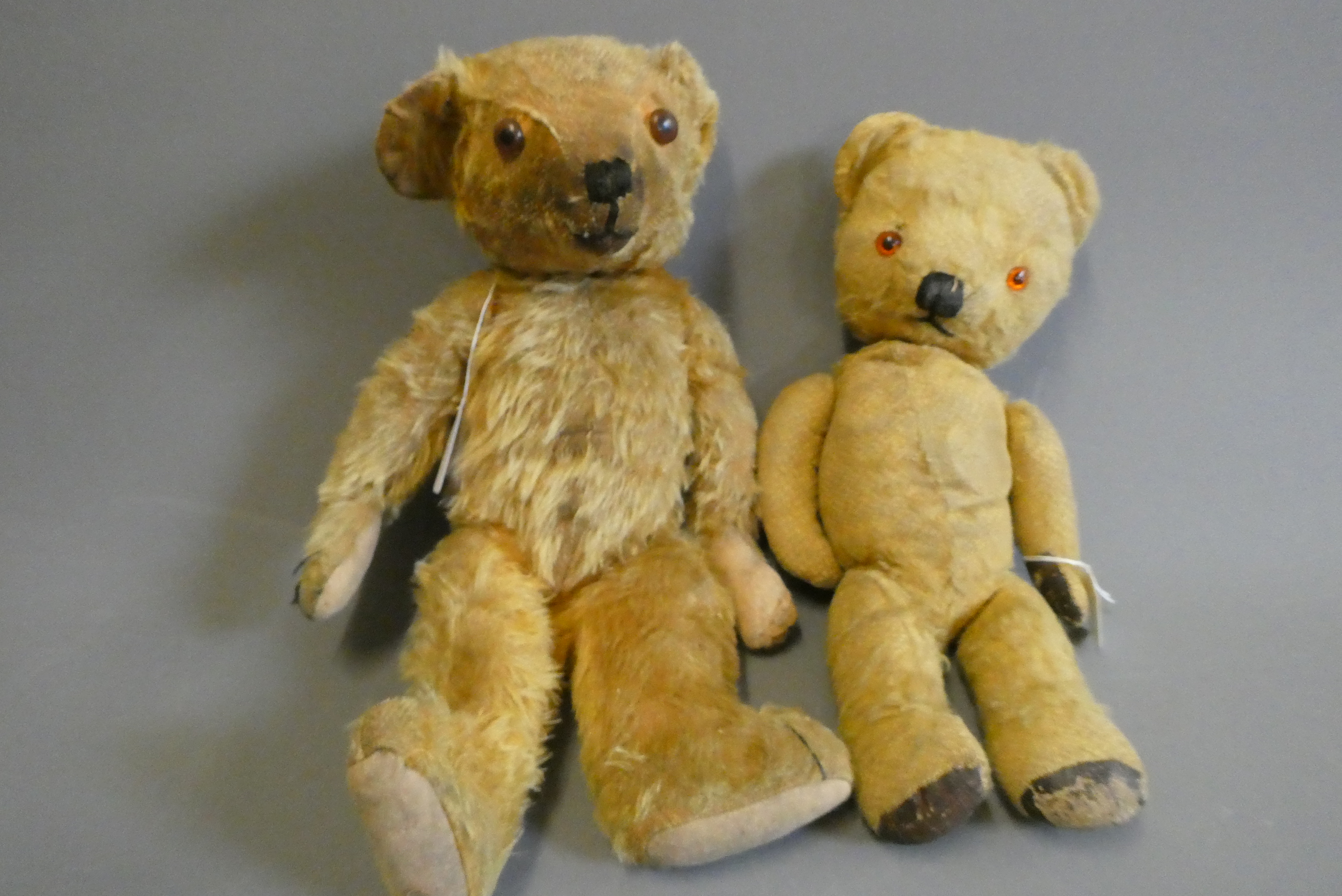 Two vintage teddy bears, one 17 1/2" long with hump to back and remnants of label to foot, the other Image