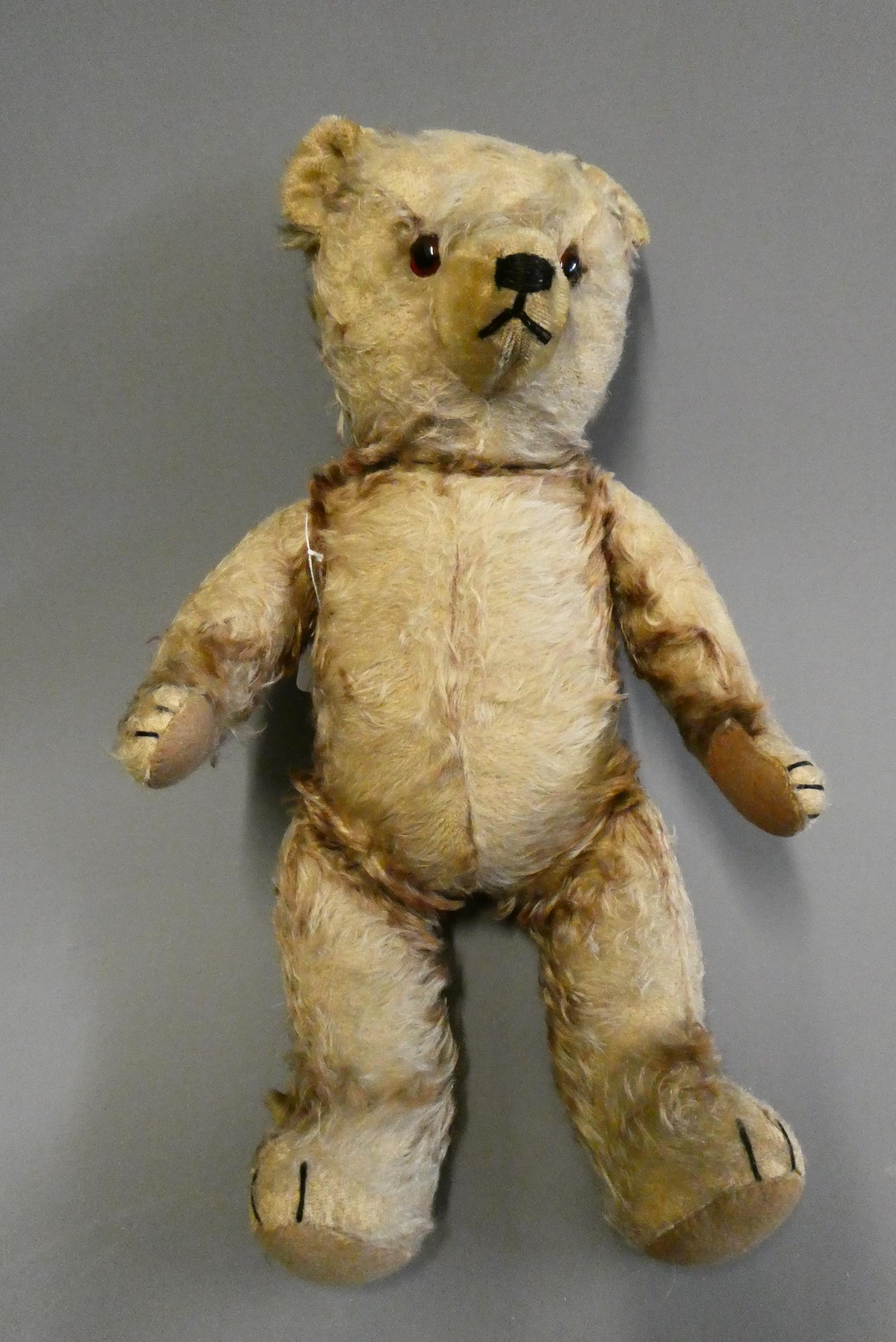Vintage English centre seam teddy bear, with amber glass eyes, shaved muzzle, sewn nose, and later Image