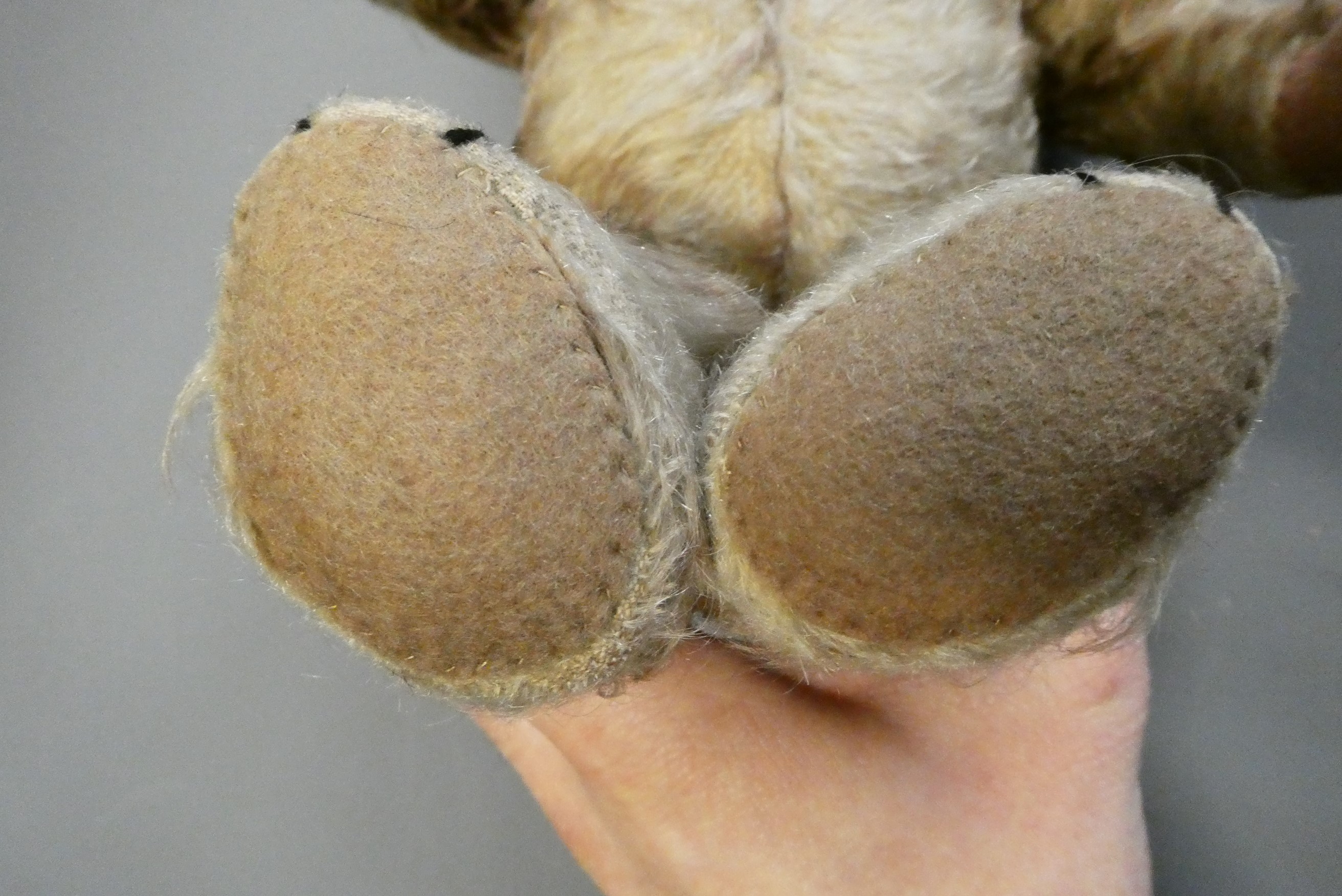 Vintage English centre seam teddy bear, with amber glass eyes, shaved muzzle, sewn nose, and later Image