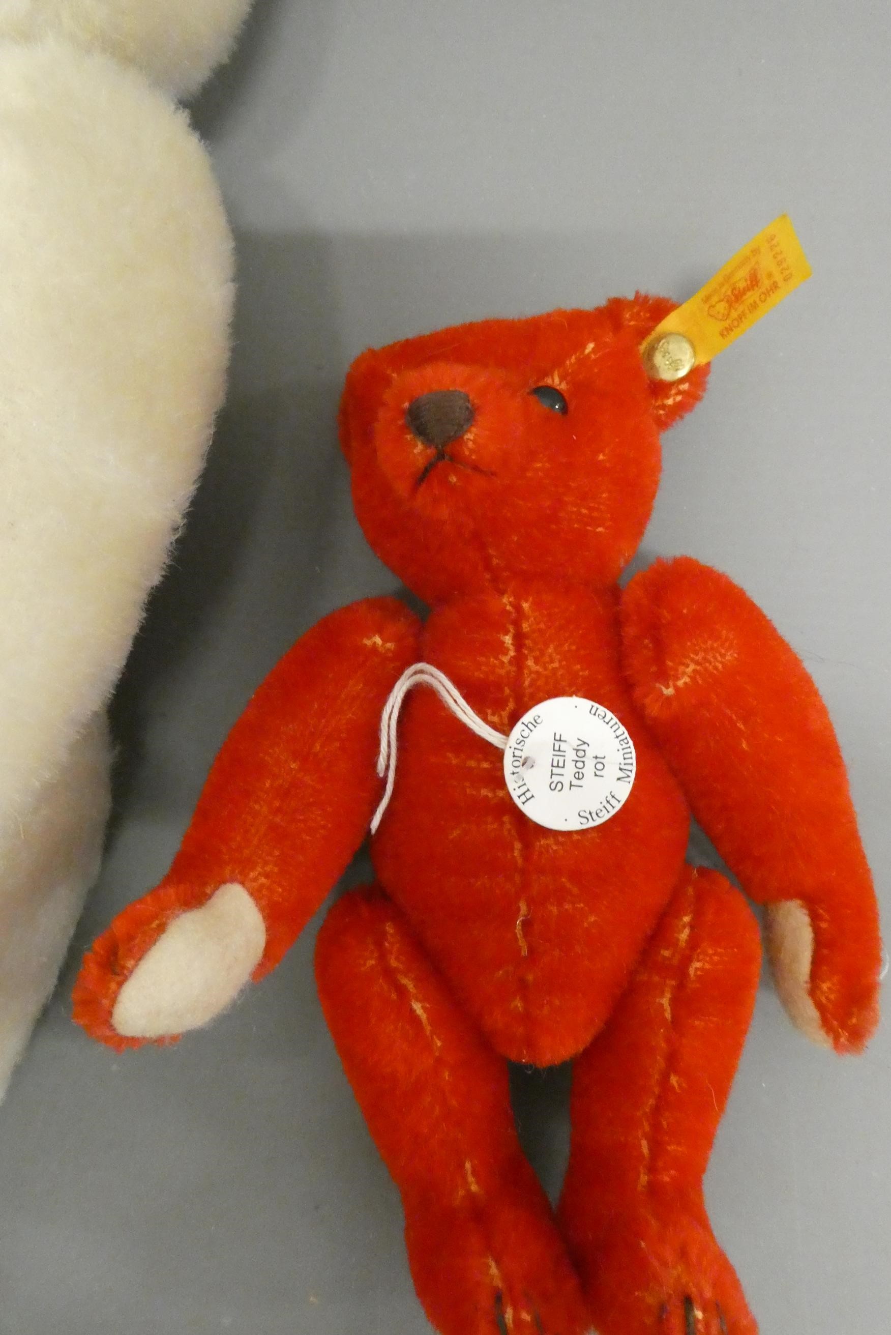 Three Steiff teddy bears, comprising a 12 1/2" white bear, a 6 3/4" red bear and a 7 3/4" teddy Image
