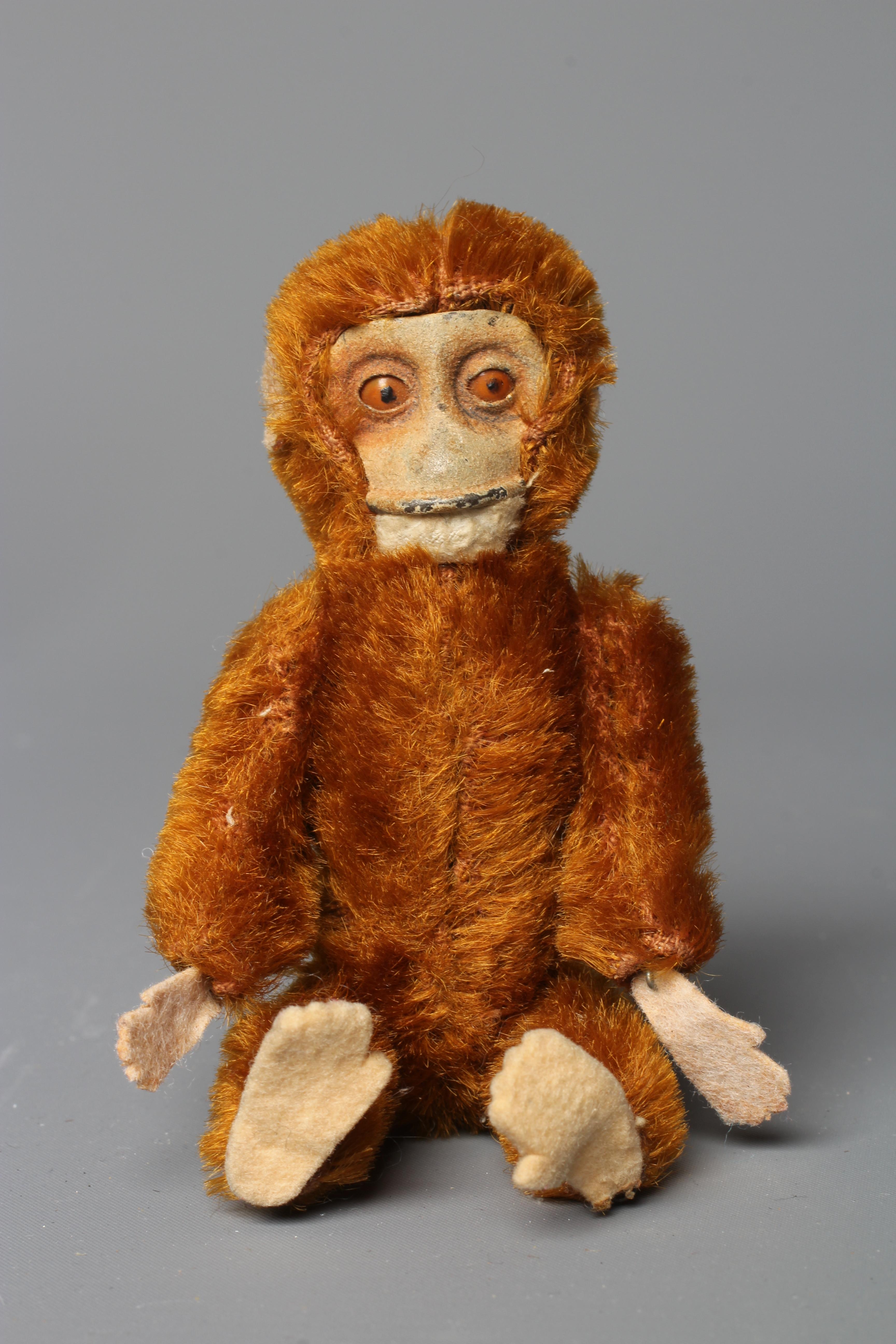 A Schuco monkey, with rotating head, jointed shoulders and hips, brown plush, felt face, hands and Image
