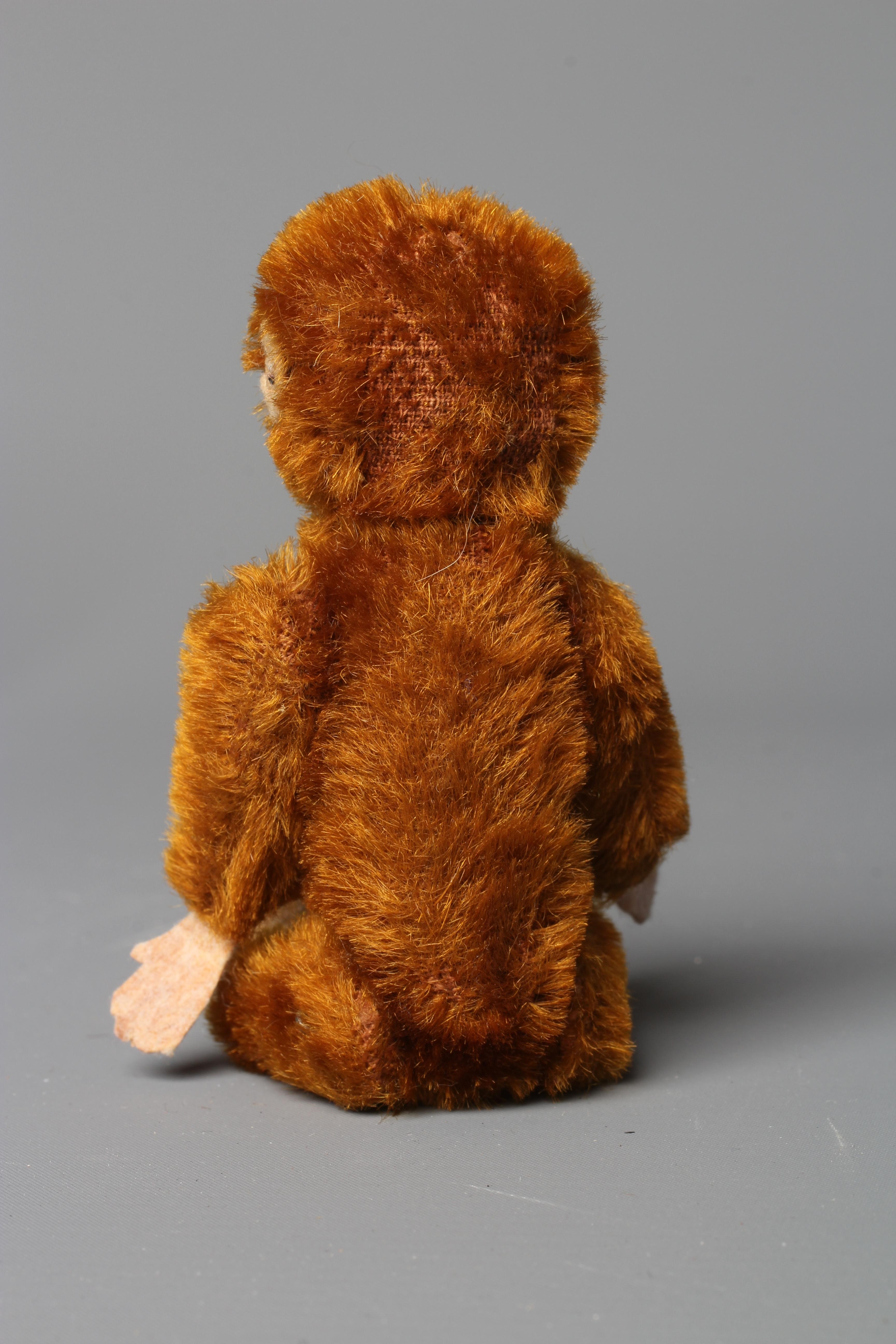 A Schuco monkey, with rotating head, jointed shoulders and hips, brown plush, felt face, hands and Image