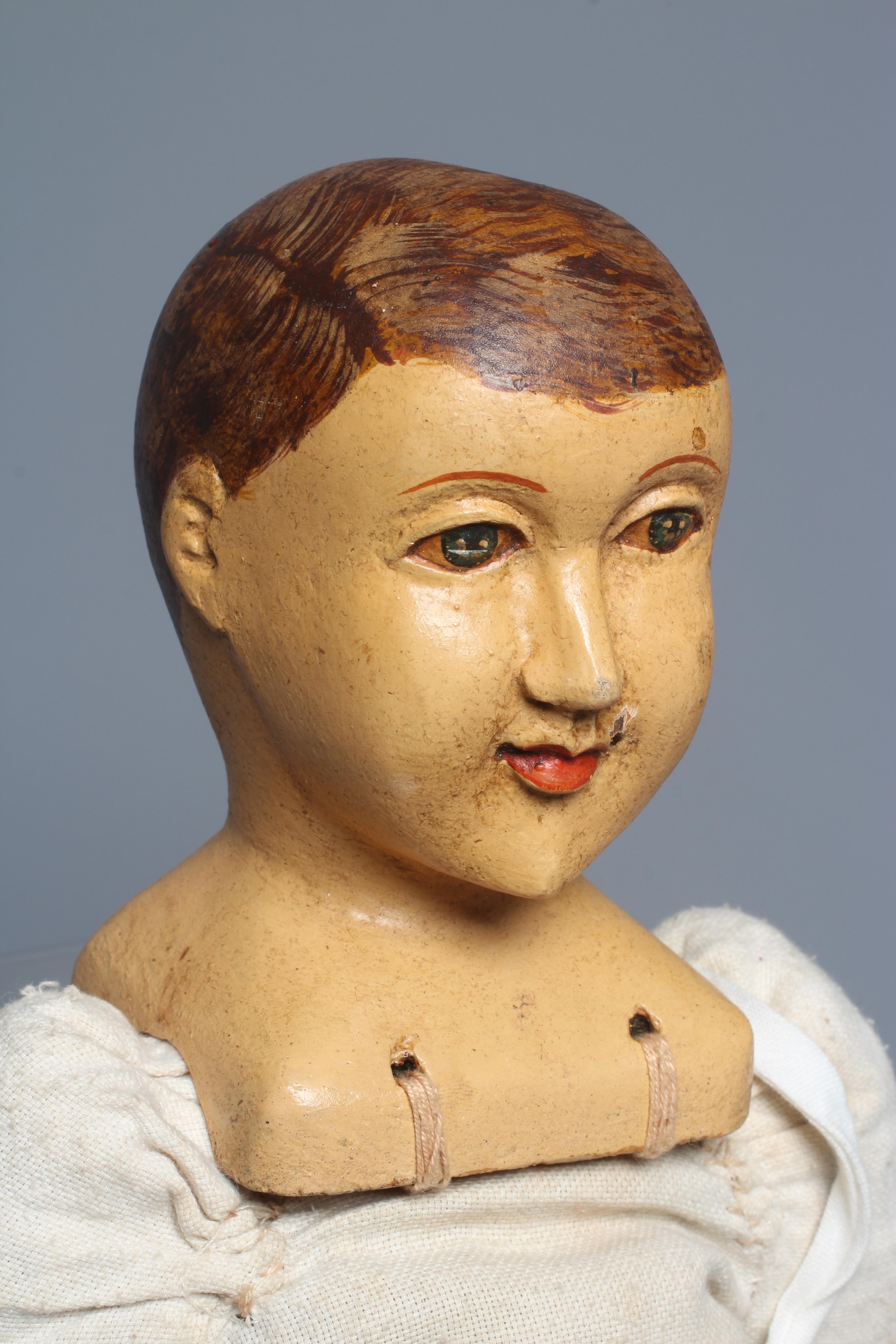 A folk art male doll, possibly a Santos doll, with carved wood and plaster head, painted features, Image