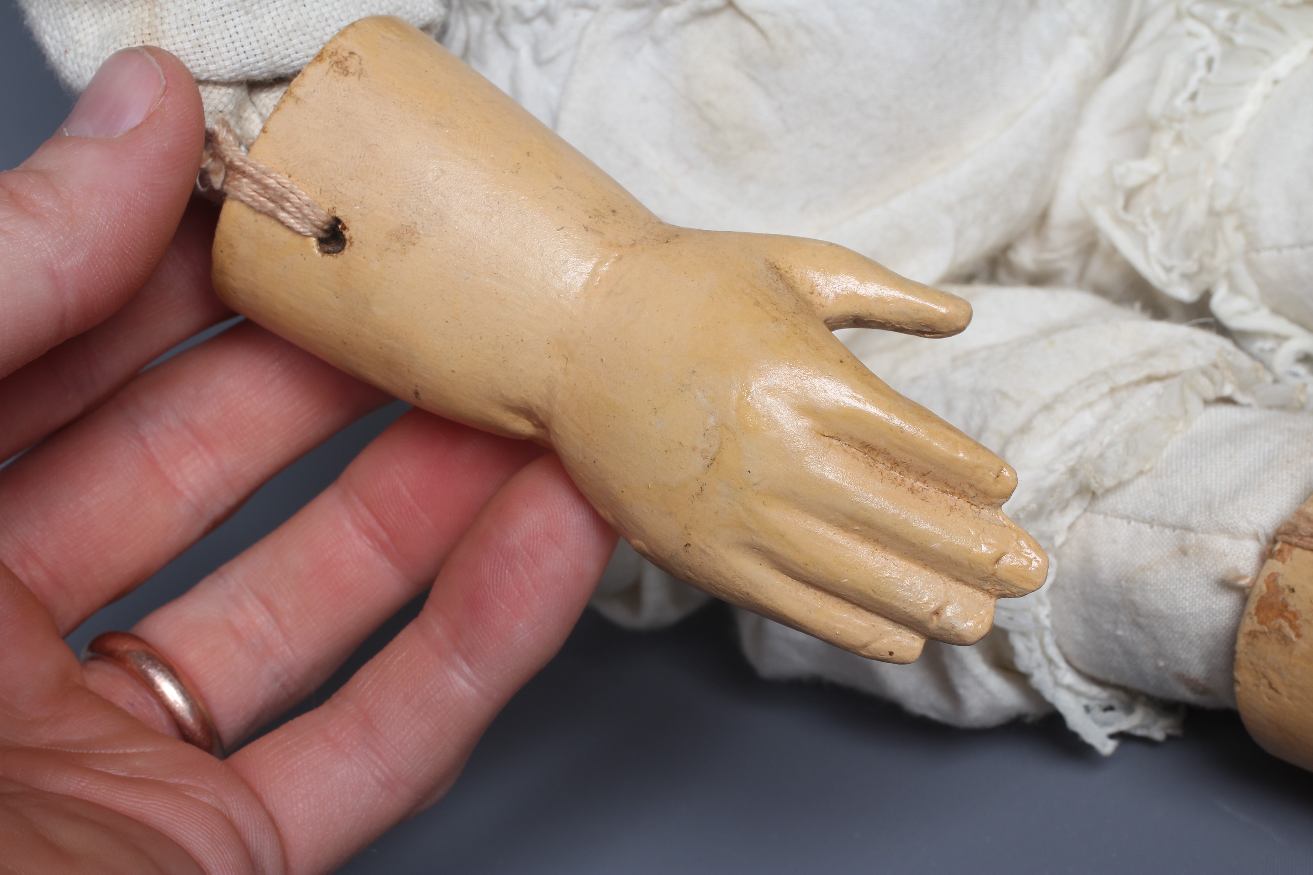 A folk art male doll, possibly a Santos doll, with carved wood and plaster head, painted features, Image