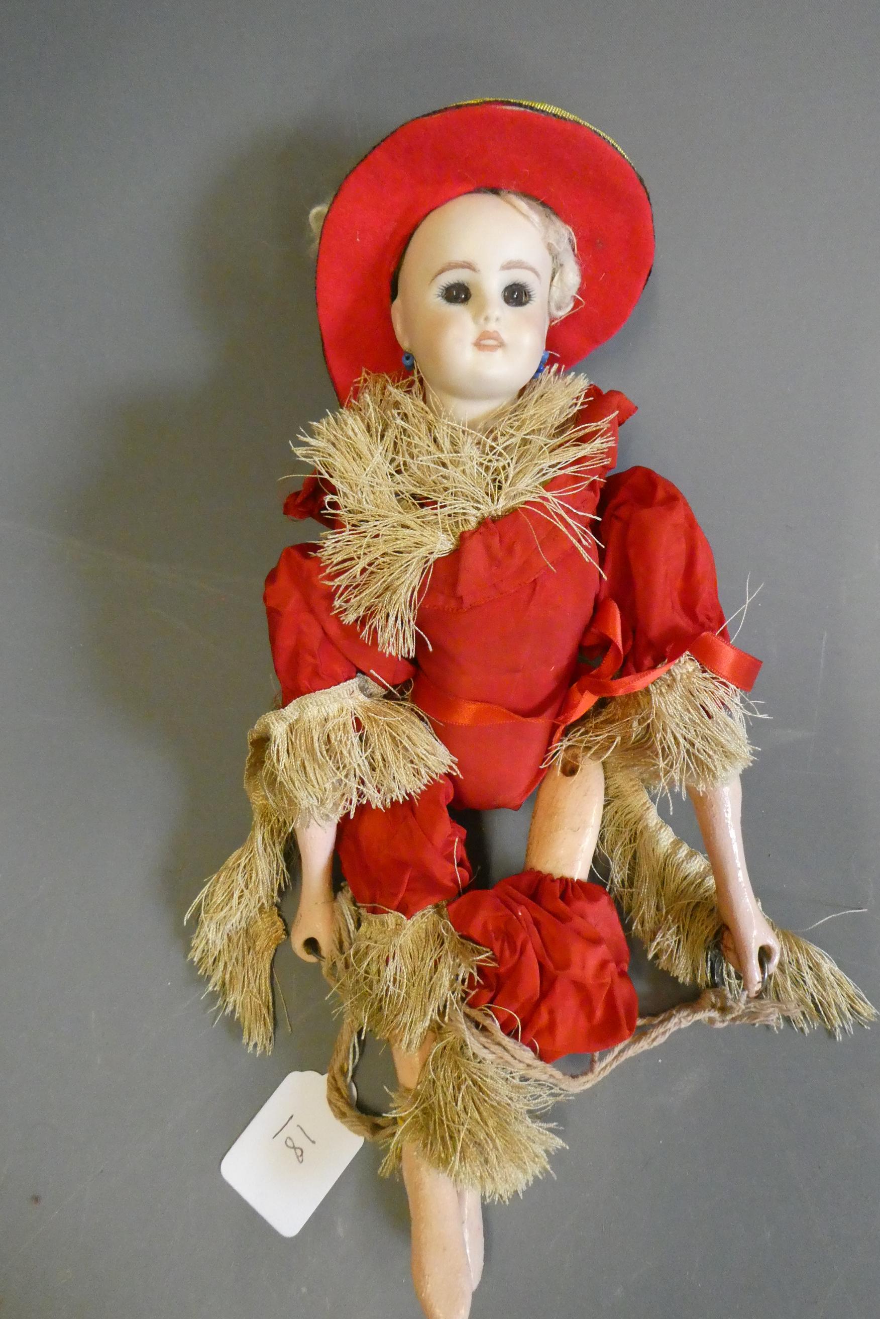 A bisque head acrobat doll, with brown glass fixed eyes, mouth moulded open with teeth, pierced Image