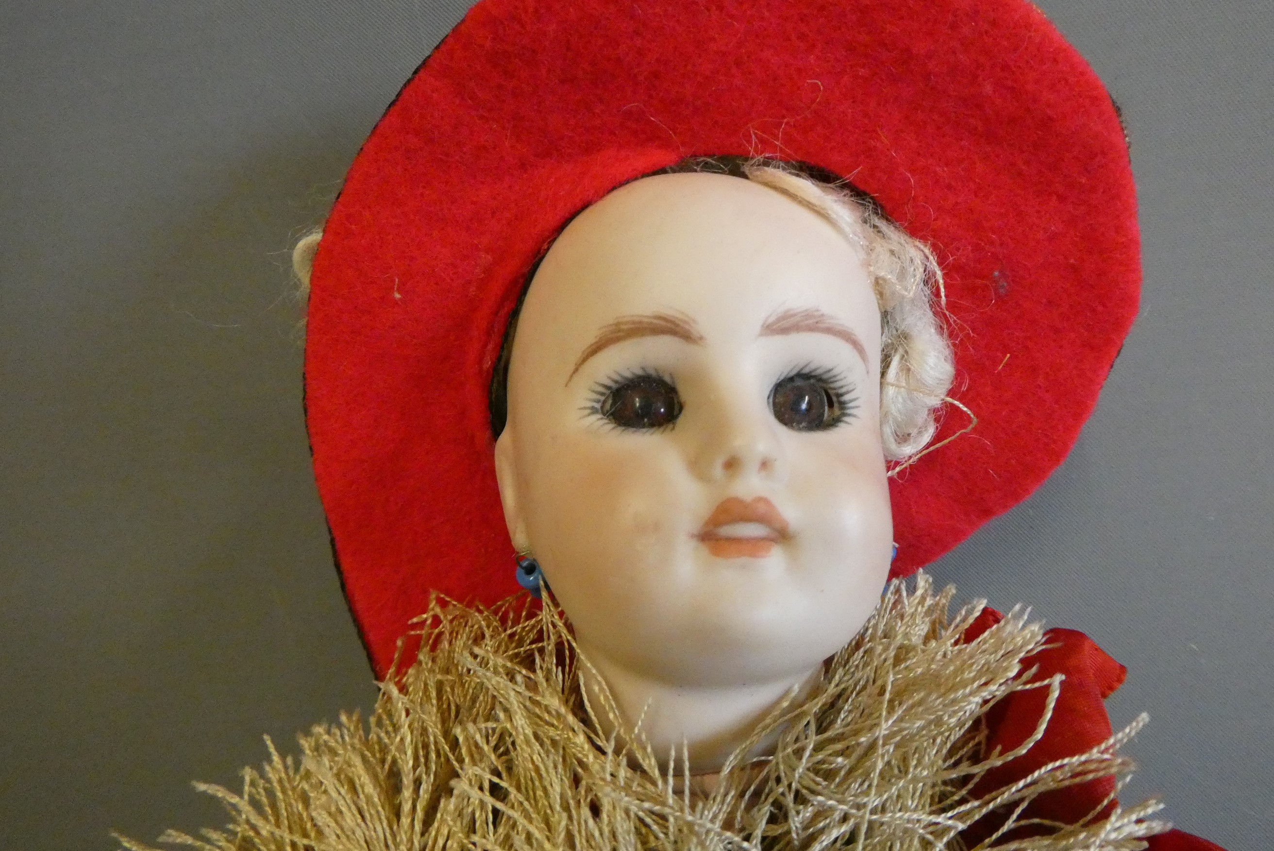 A bisque head acrobat doll, with brown glass fixed eyes, mouth moulded open with teeth, pierced Image