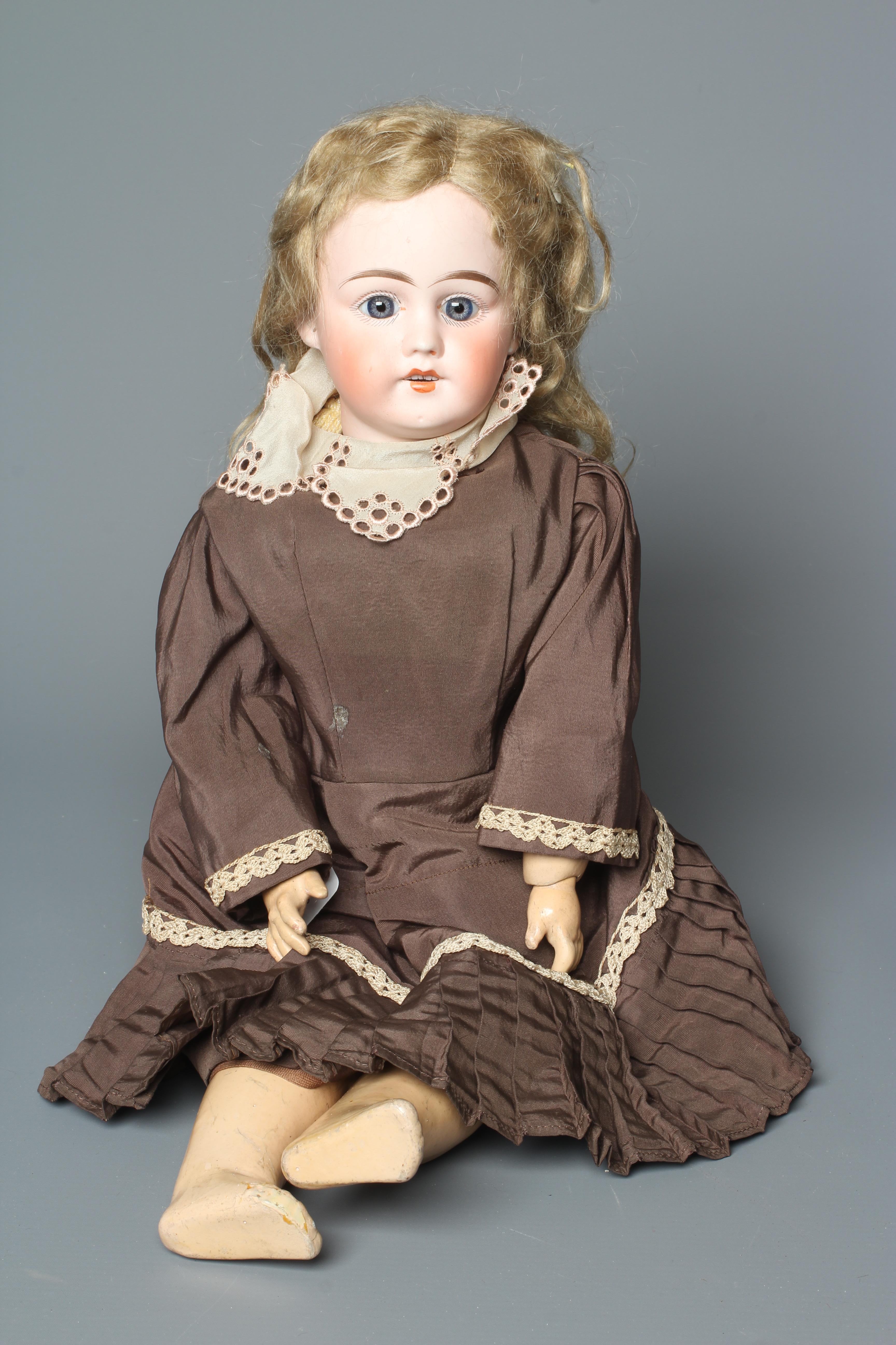 A bisque socket head doll, with blue glass fixed eyes, open mouth, teeth, pierced ears, blond wig, Image