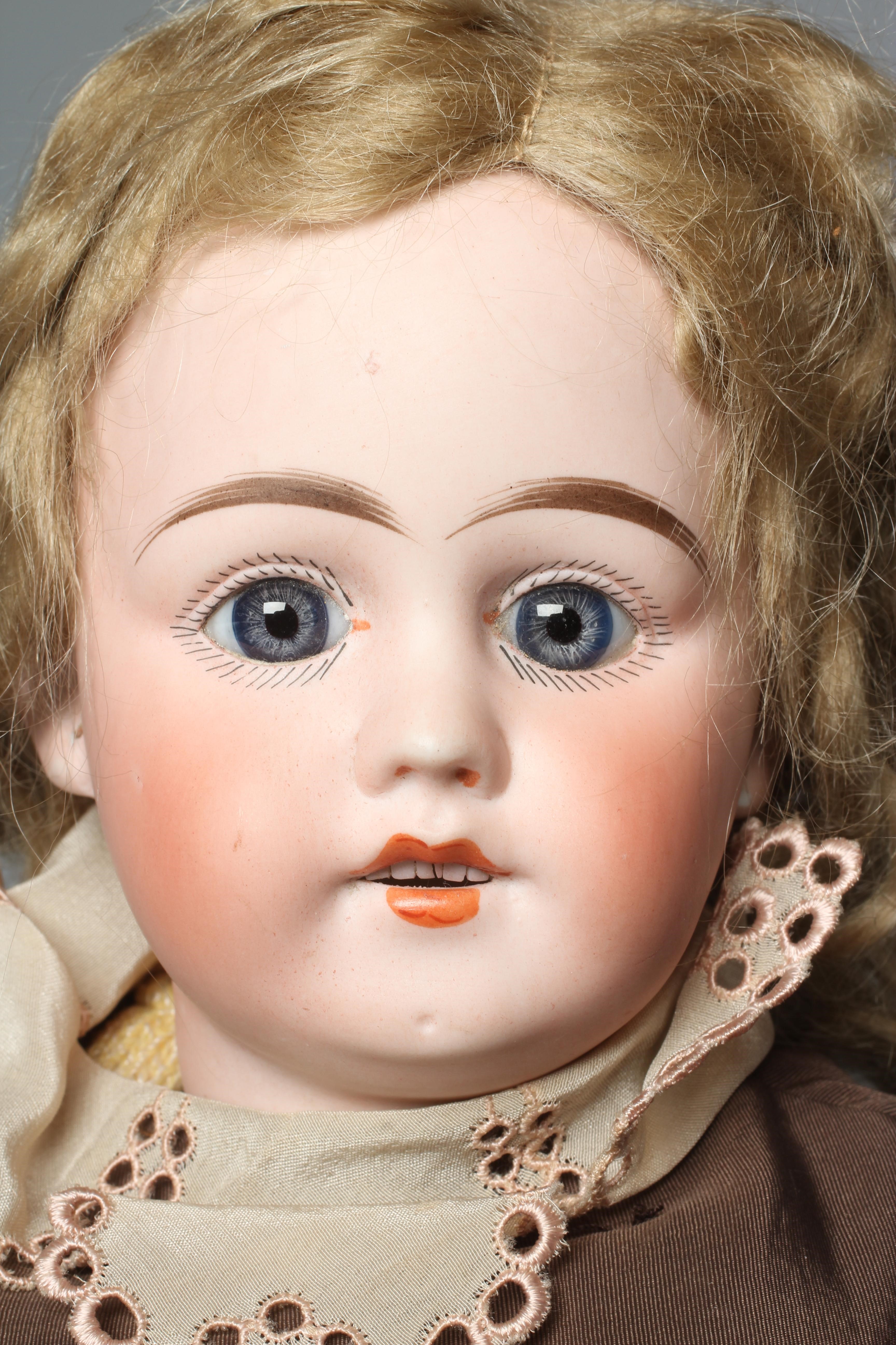 A bisque socket head doll, with blue glass fixed eyes, open mouth, teeth, pierced ears, blond wig, Image
