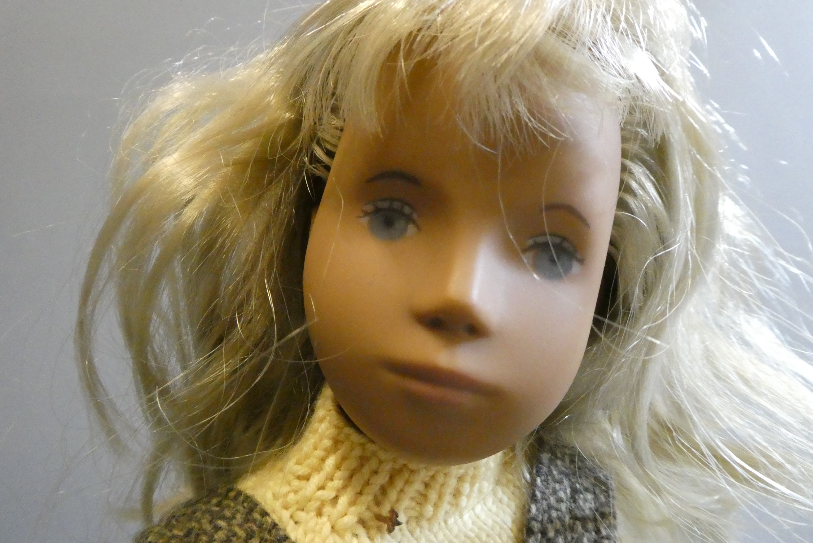 Sasha girl doll, with blond hair and jointed body, 16" long, with some spare clothing Image