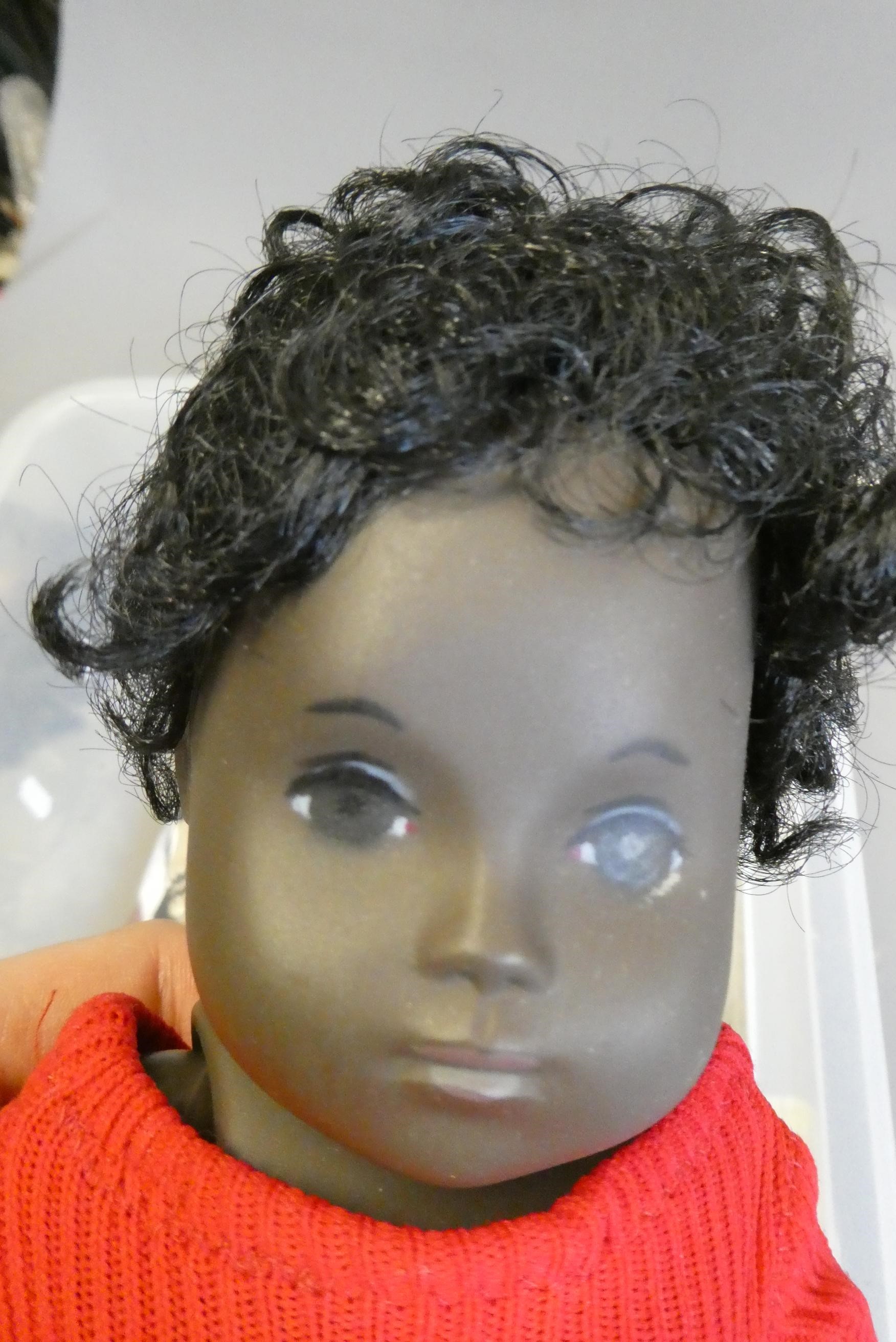 Sasha baby doll, with black curly hair and jointed body, together with Sasha clothing, four Sasha Image