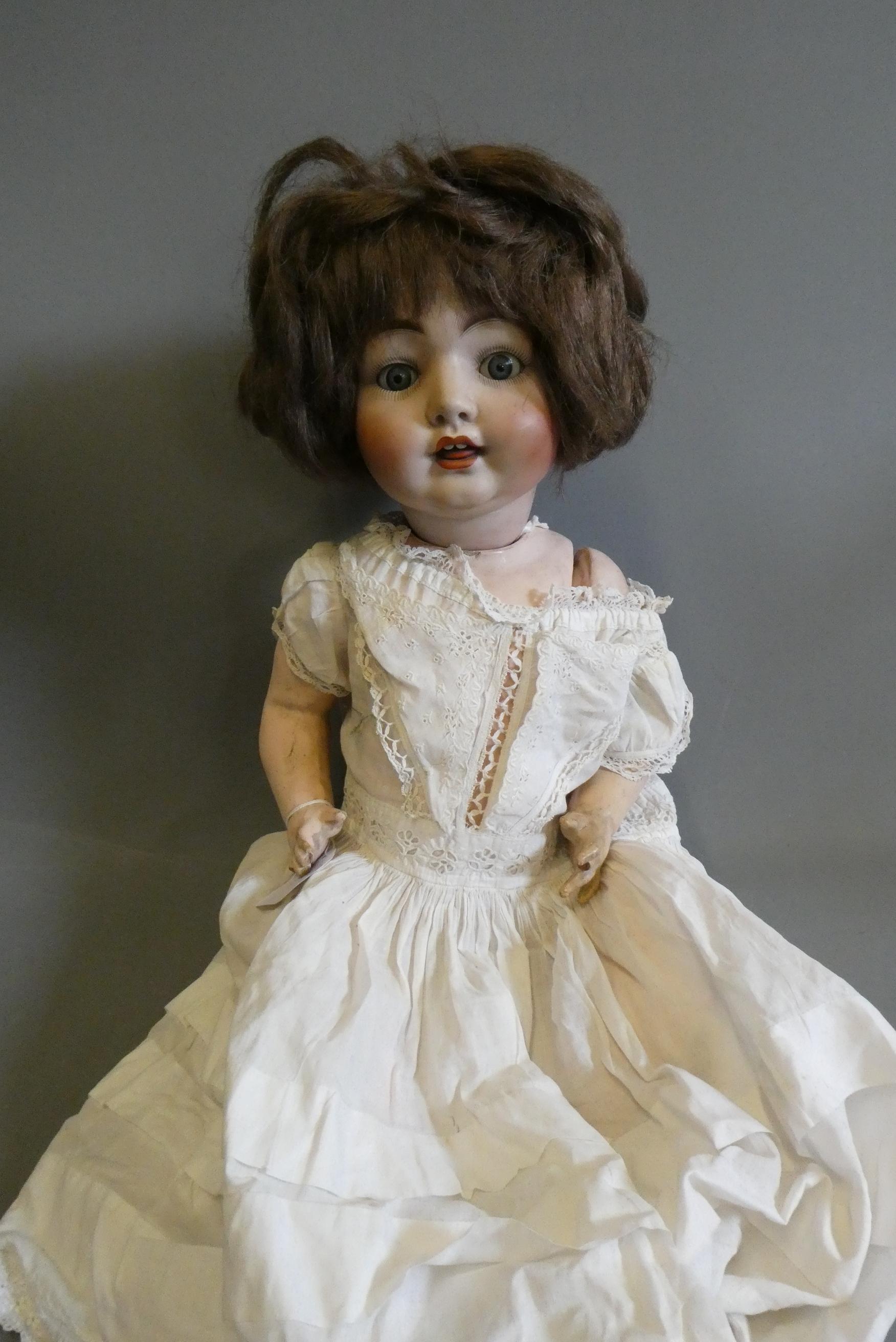 A bisque socket head character doll, with blue glass fixed eyes, open mouth, teeth, tongue, brown Image