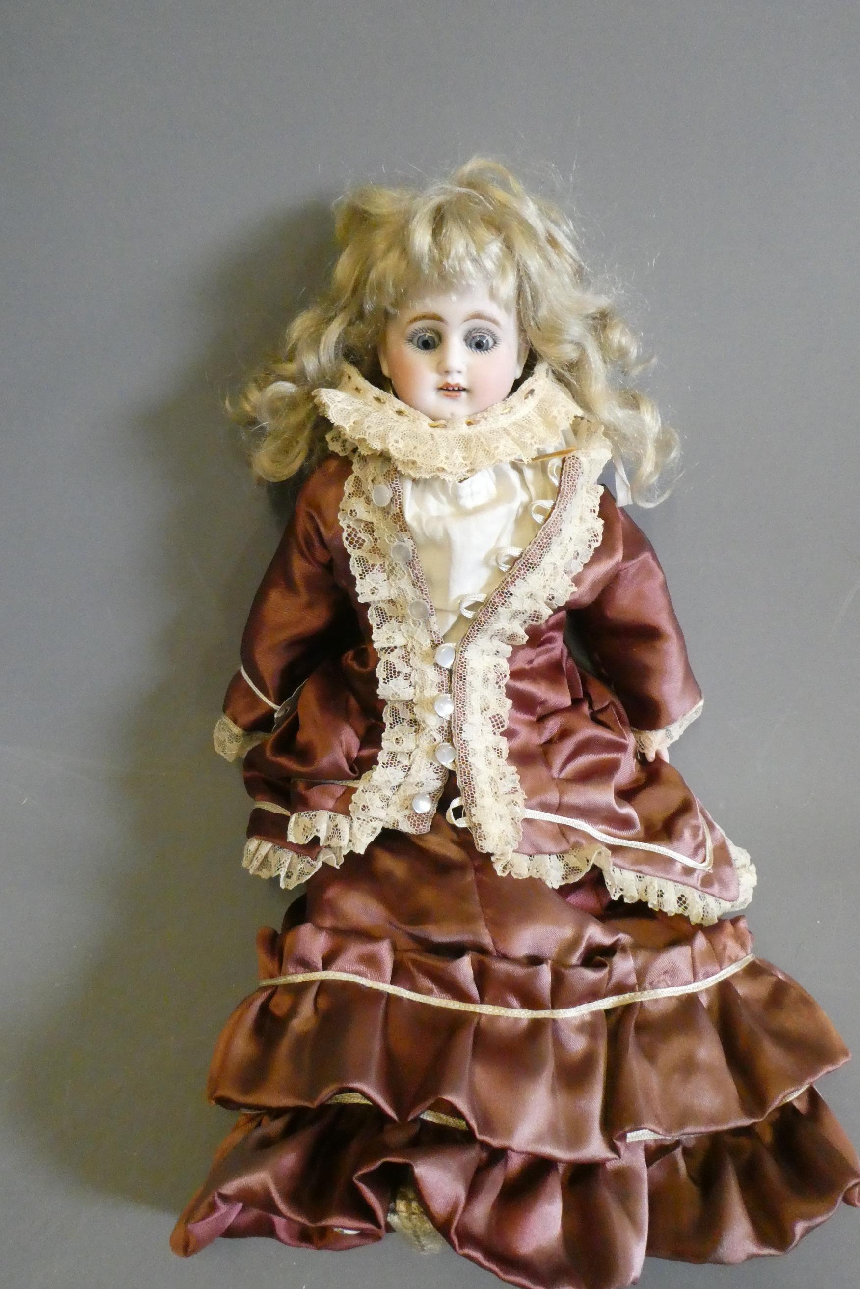 A bisque shoulder head doll, with blue glass sleeping eyes, open mouth, teeth, kid body with jointed Image