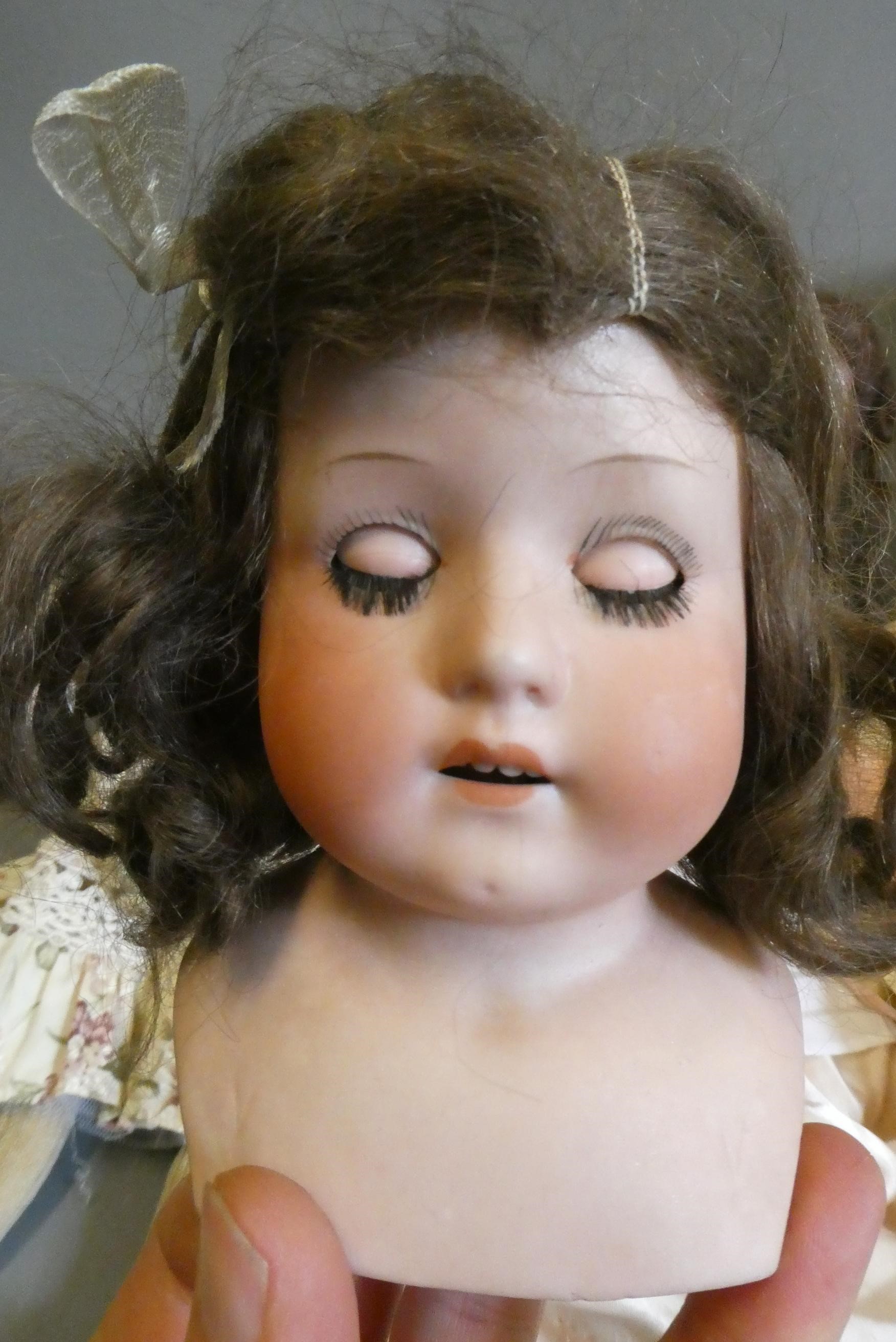 Three bisque head dolls Image
