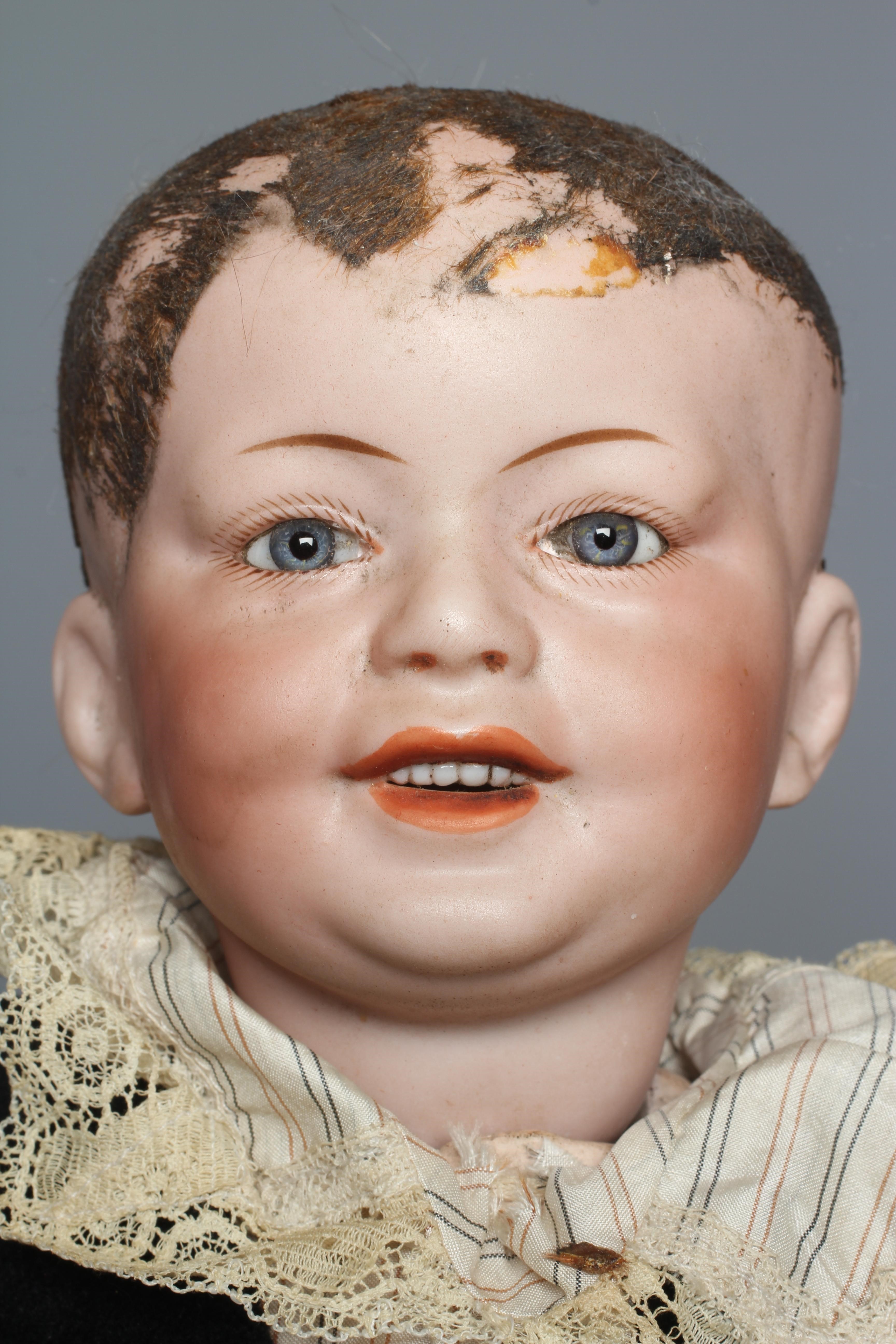 An SFBJ bisque socket head character boy doll, with blue glass fixed eyes, open mouth, teeth, Image
