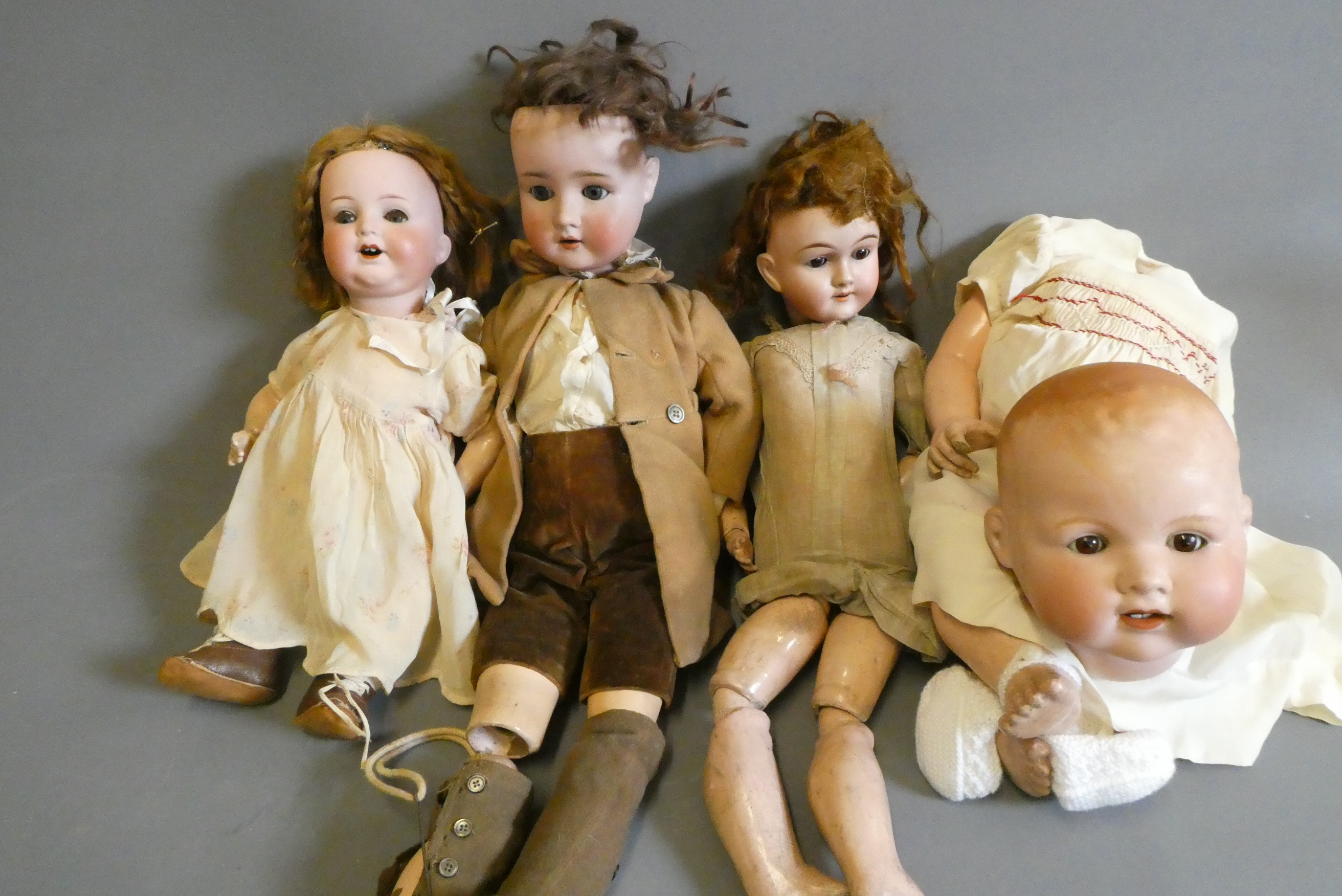 Four bisque socket head dolls Image