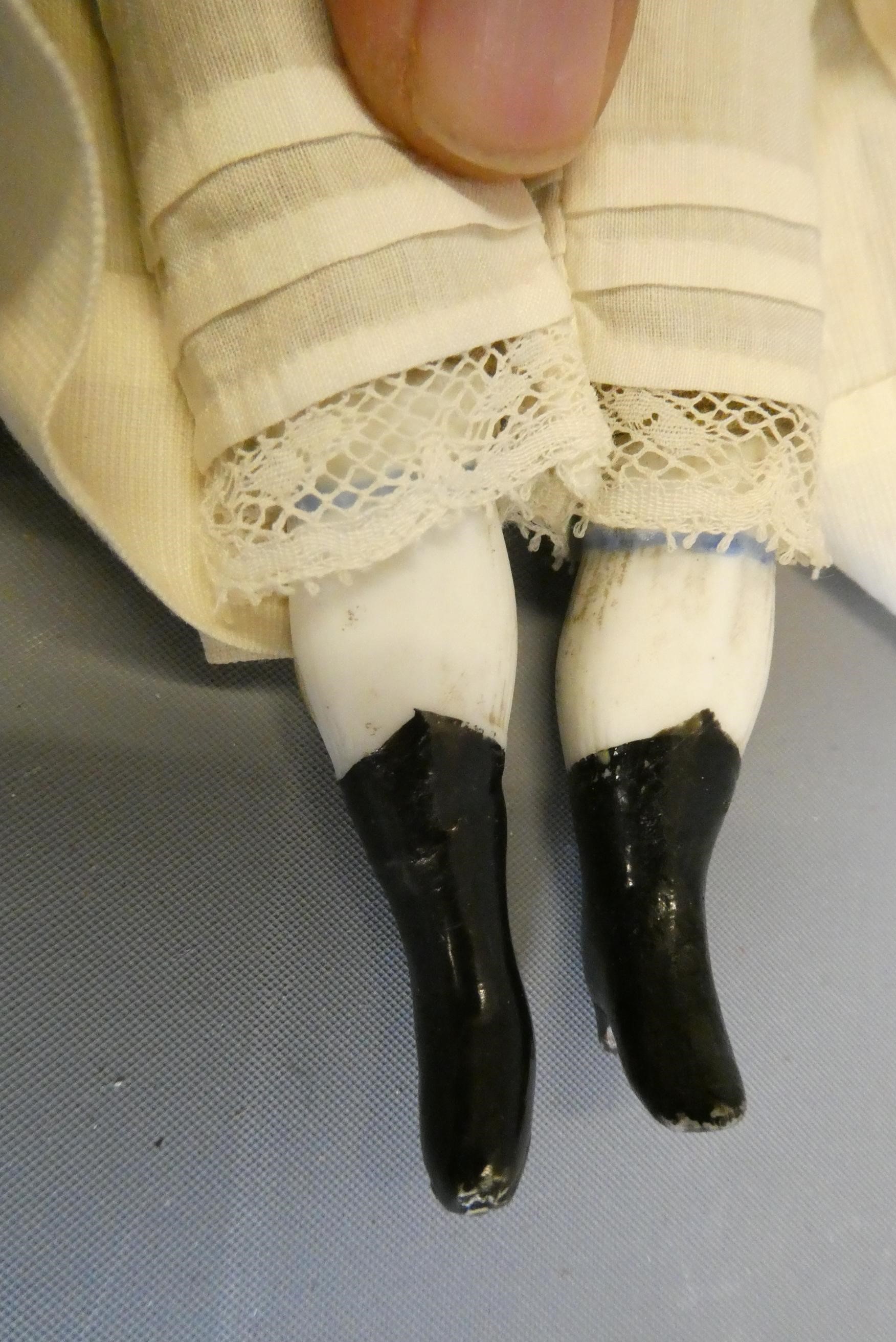 A bisque shoulder head doll, possible Alt, Beck & Gottschalck, with moulded hair, painted features, Image