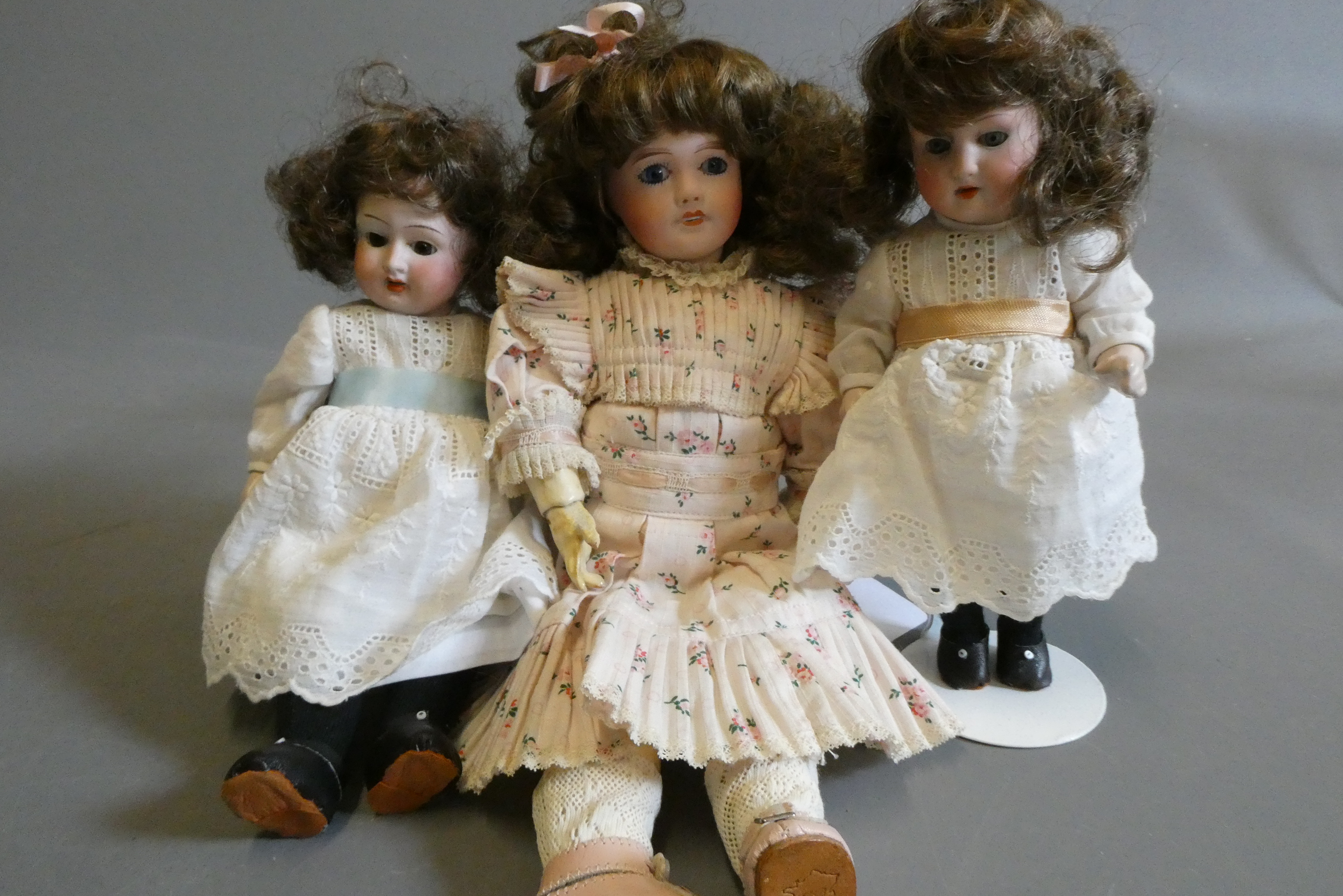 Three small bisque socket head dolls Image