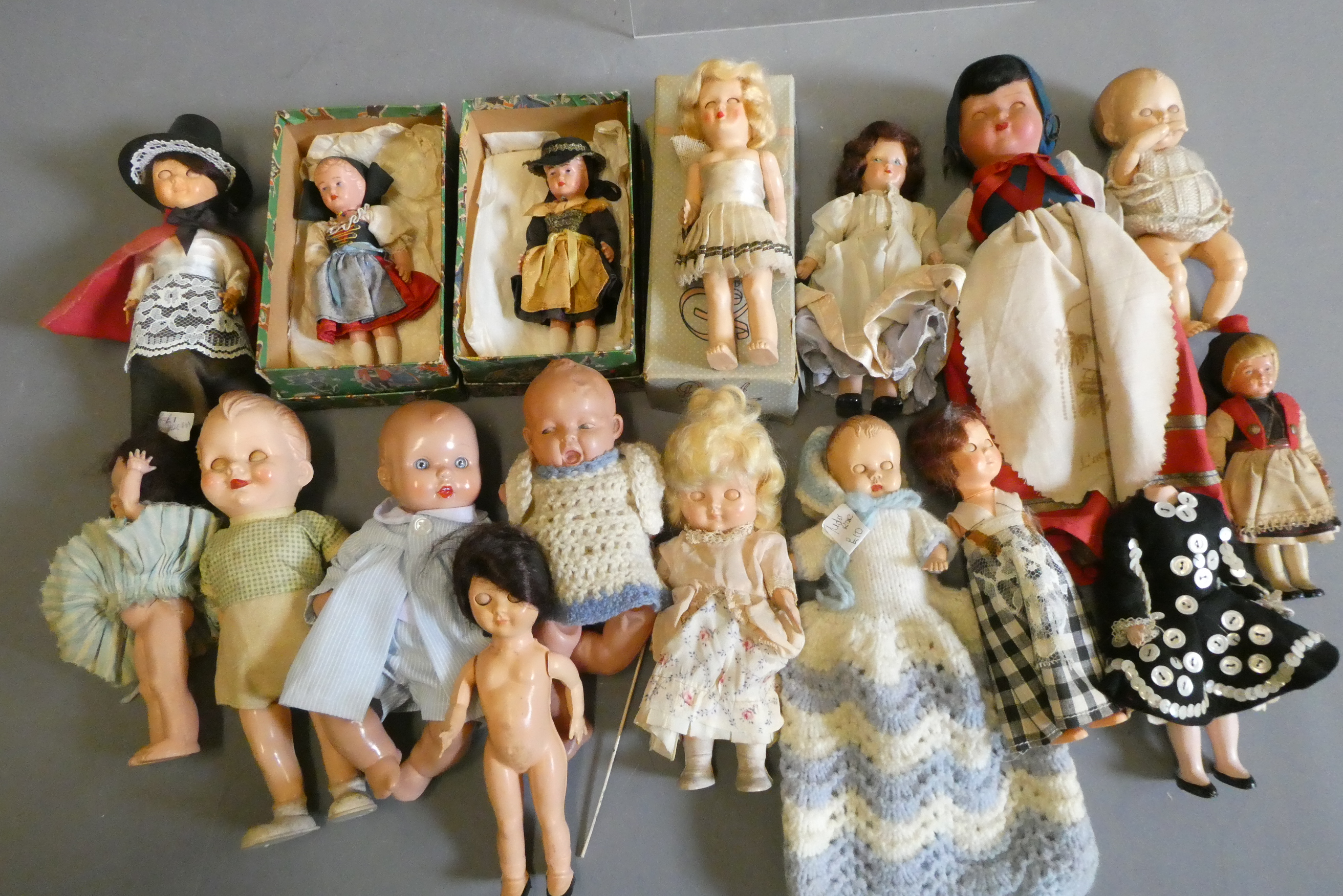 A box of vintage celluloid dolls including a Rosebud doll and others, three in original boxes Image