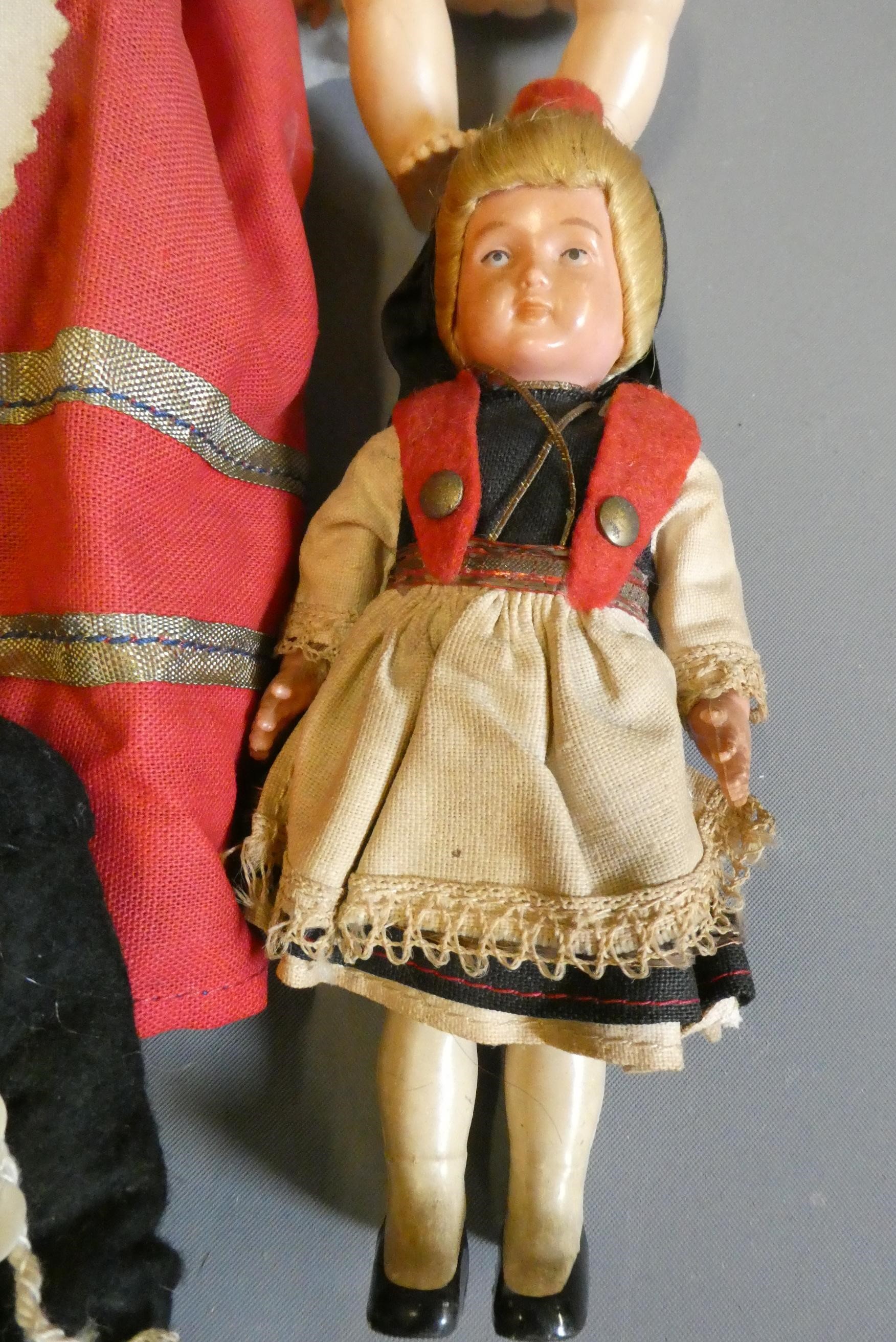 A box of vintage celluloid dolls including a Rosebud doll and others, three in original boxes Image