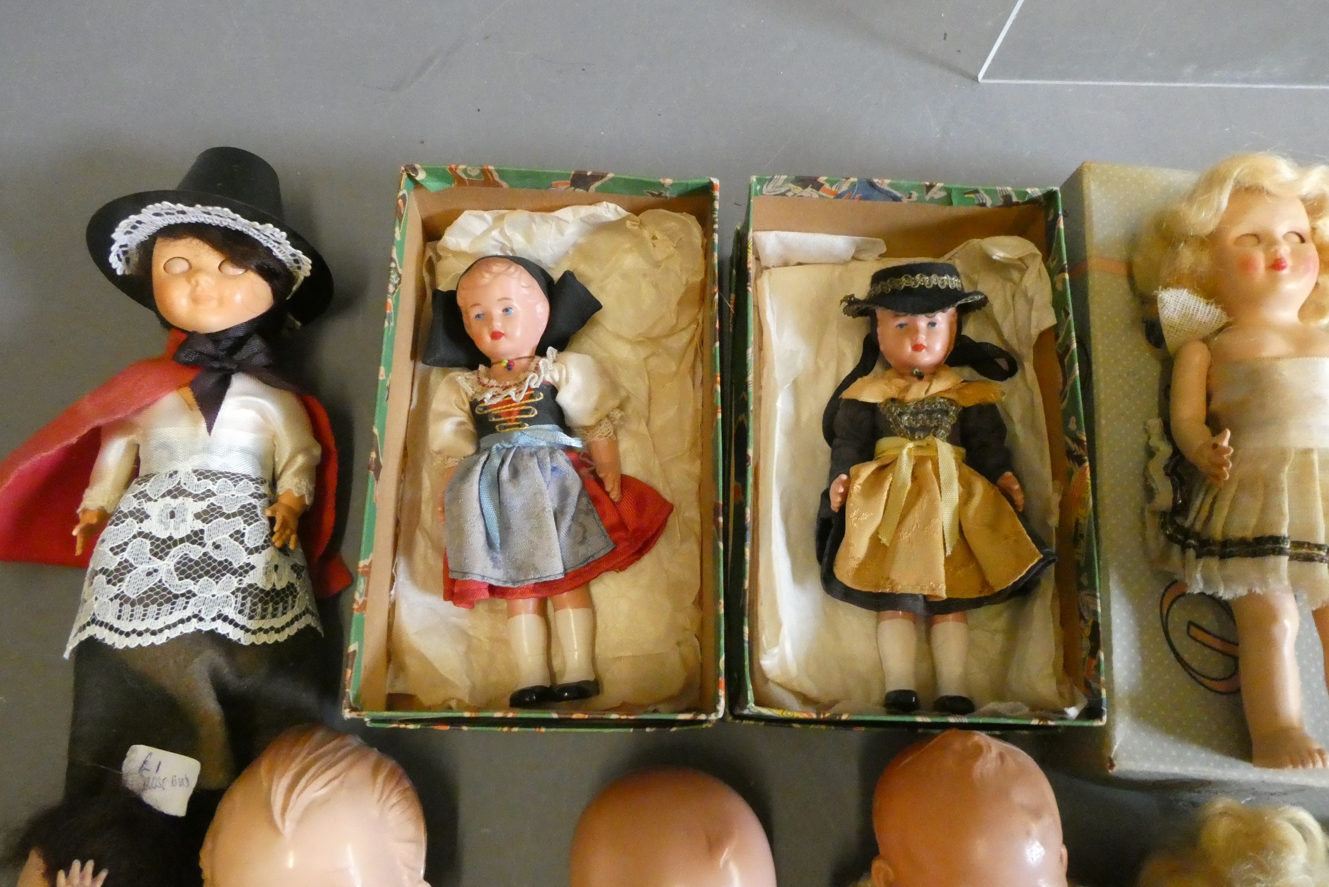 A box of vintage celluloid dolls including a Rosebud doll and others, three in original boxes Image