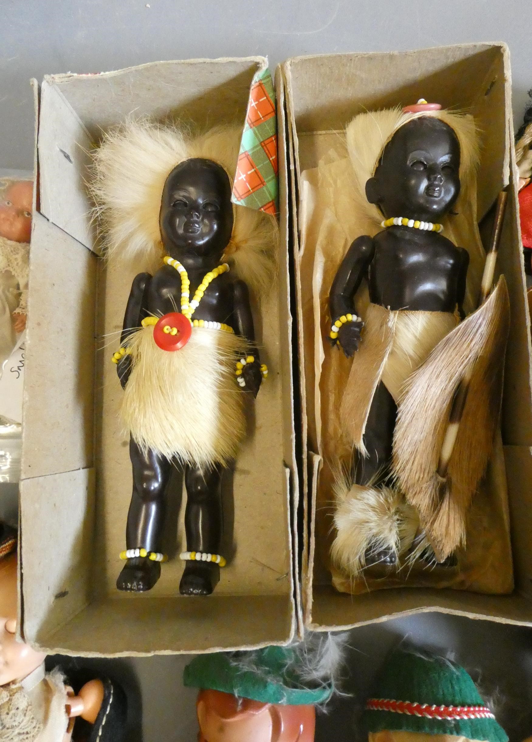 Two boxes of small vintage celluloid dolls, including Scotch dolls and two Zulus Image