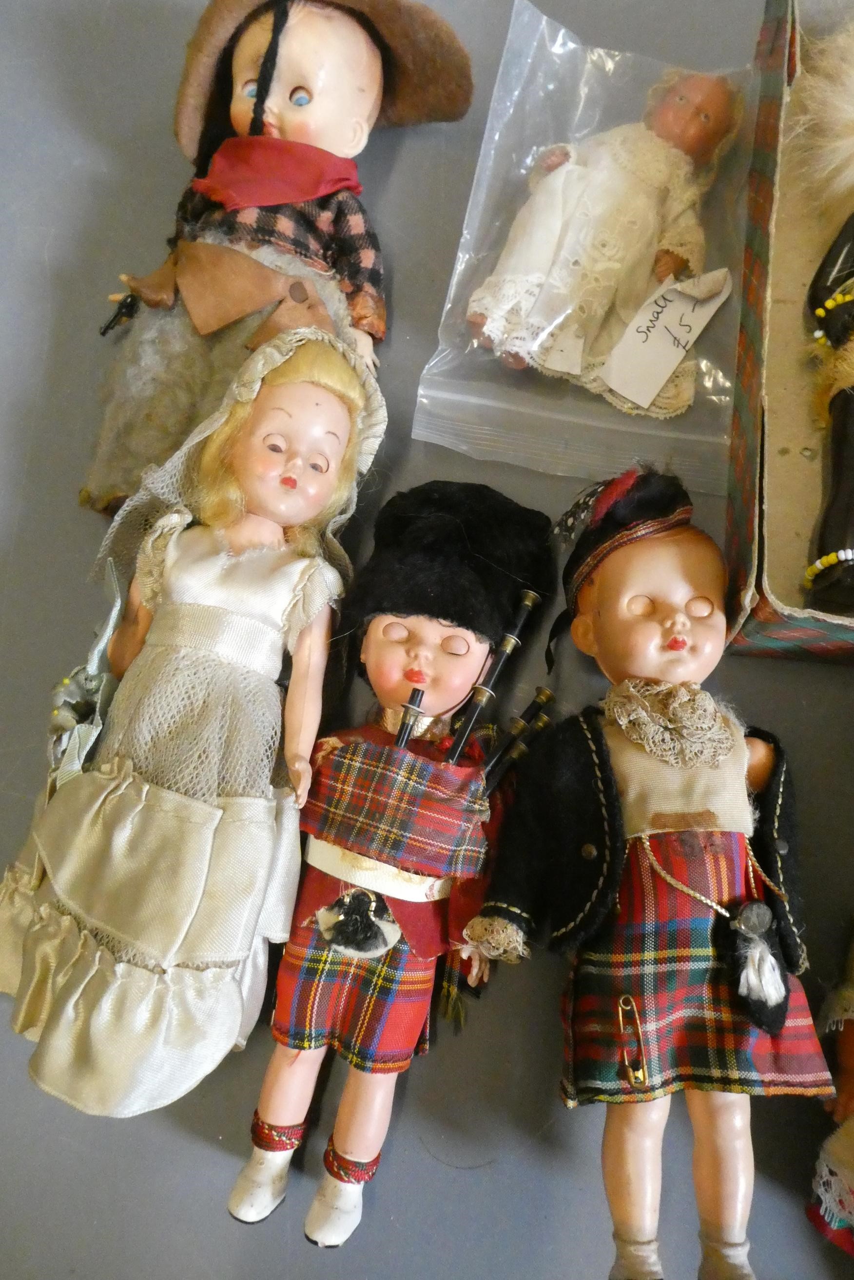 Two boxes of small vintage celluloid dolls, including Scotch dolls and two Zulus Image