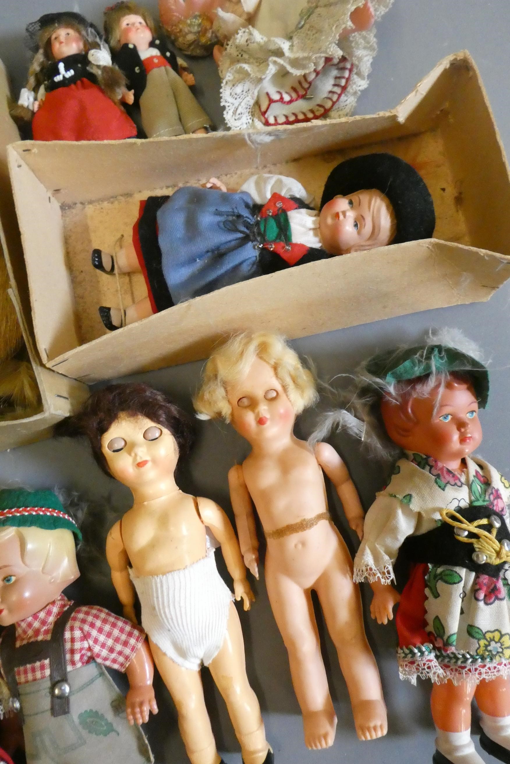 Two boxes of small vintage celluloid dolls, including Scotch dolls and two Zulus Image