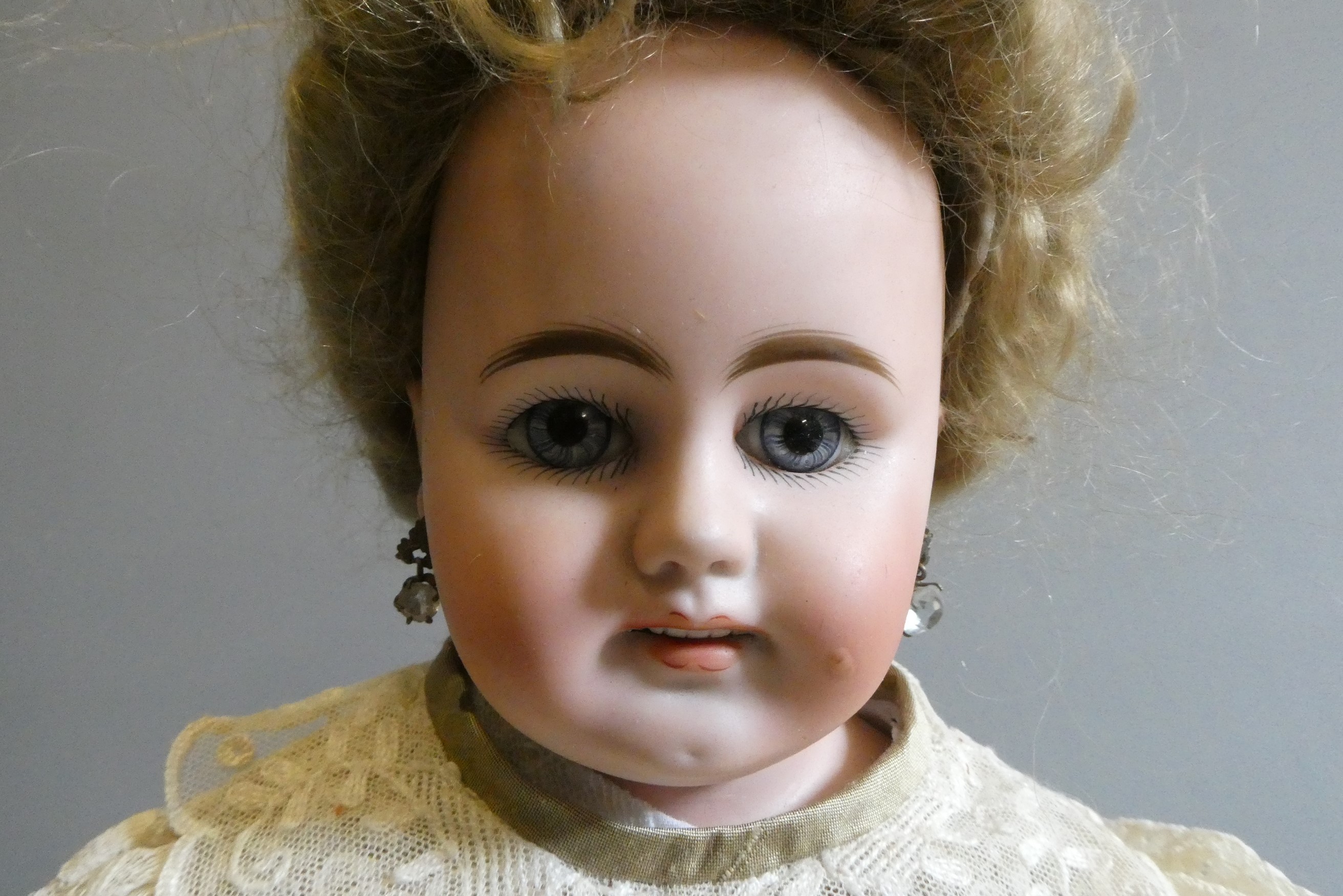 A bisque shoulder head doll, possible Bahr & Proschild, with blue glass fixed eyes, open mouth, Image