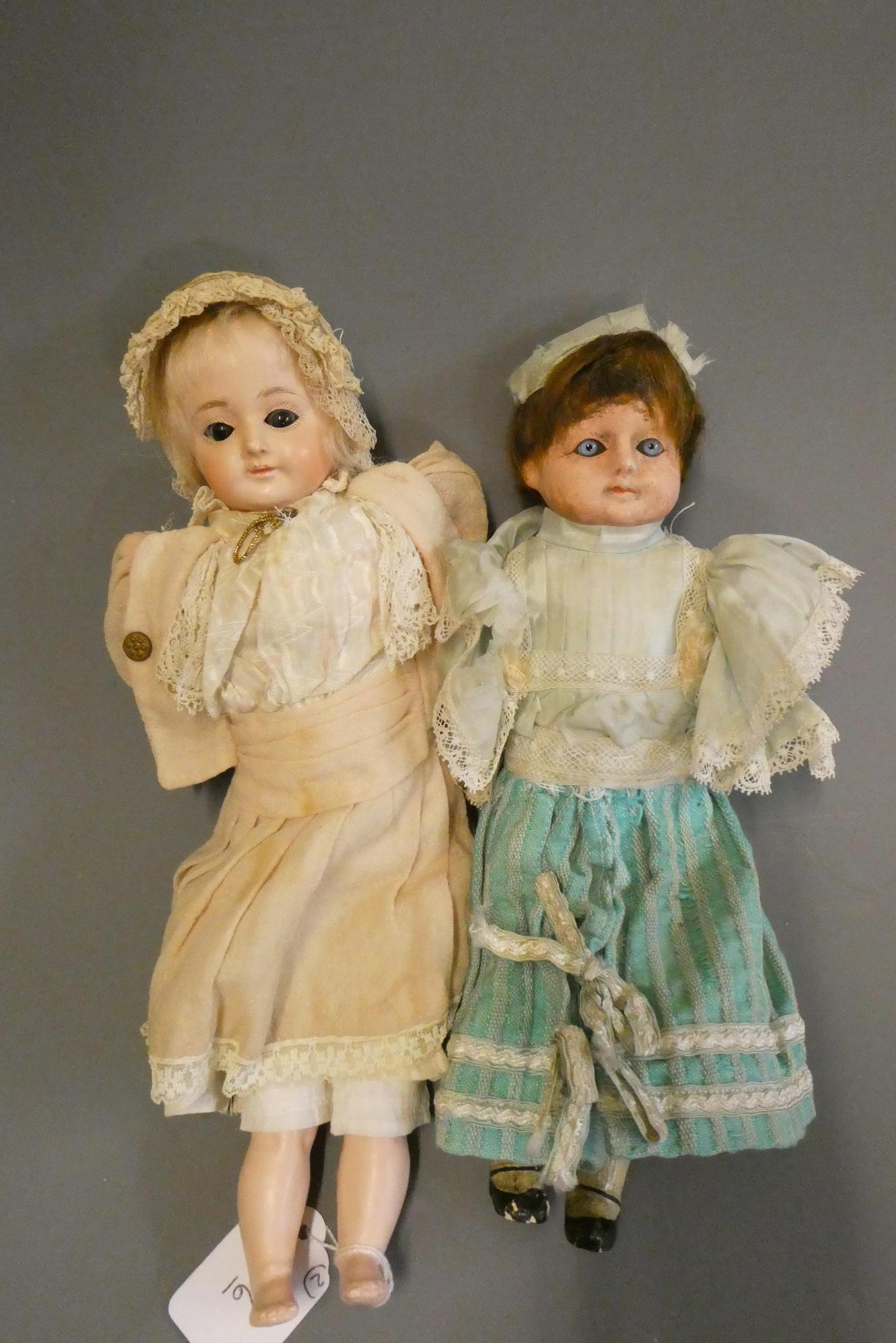 Two early composition dolls, both with glass eyes (one fixed, one sleeping), composition lower limbs Image