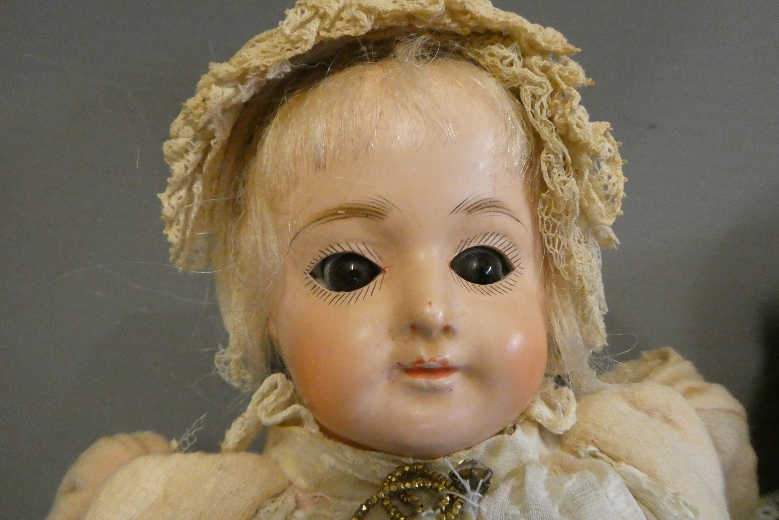 Two early composition dolls, both with glass eyes (one fixed, one sleeping), composition lower limbs Image