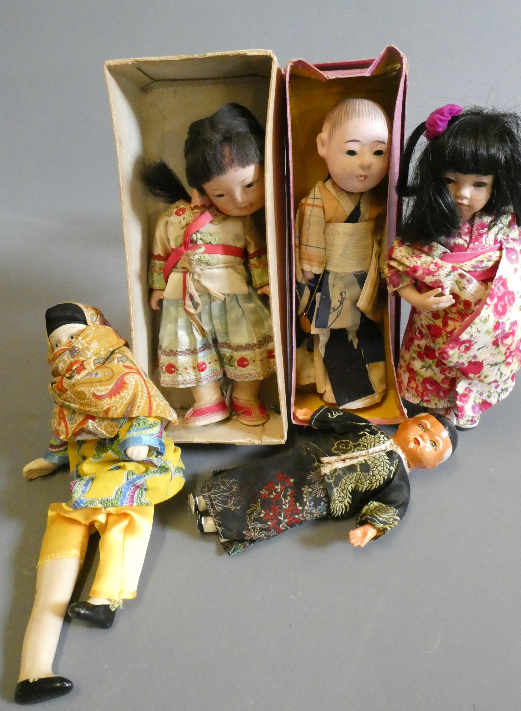 Five oriental dolls, including an 8" composition boy in original box, two bisque dolls and two Image