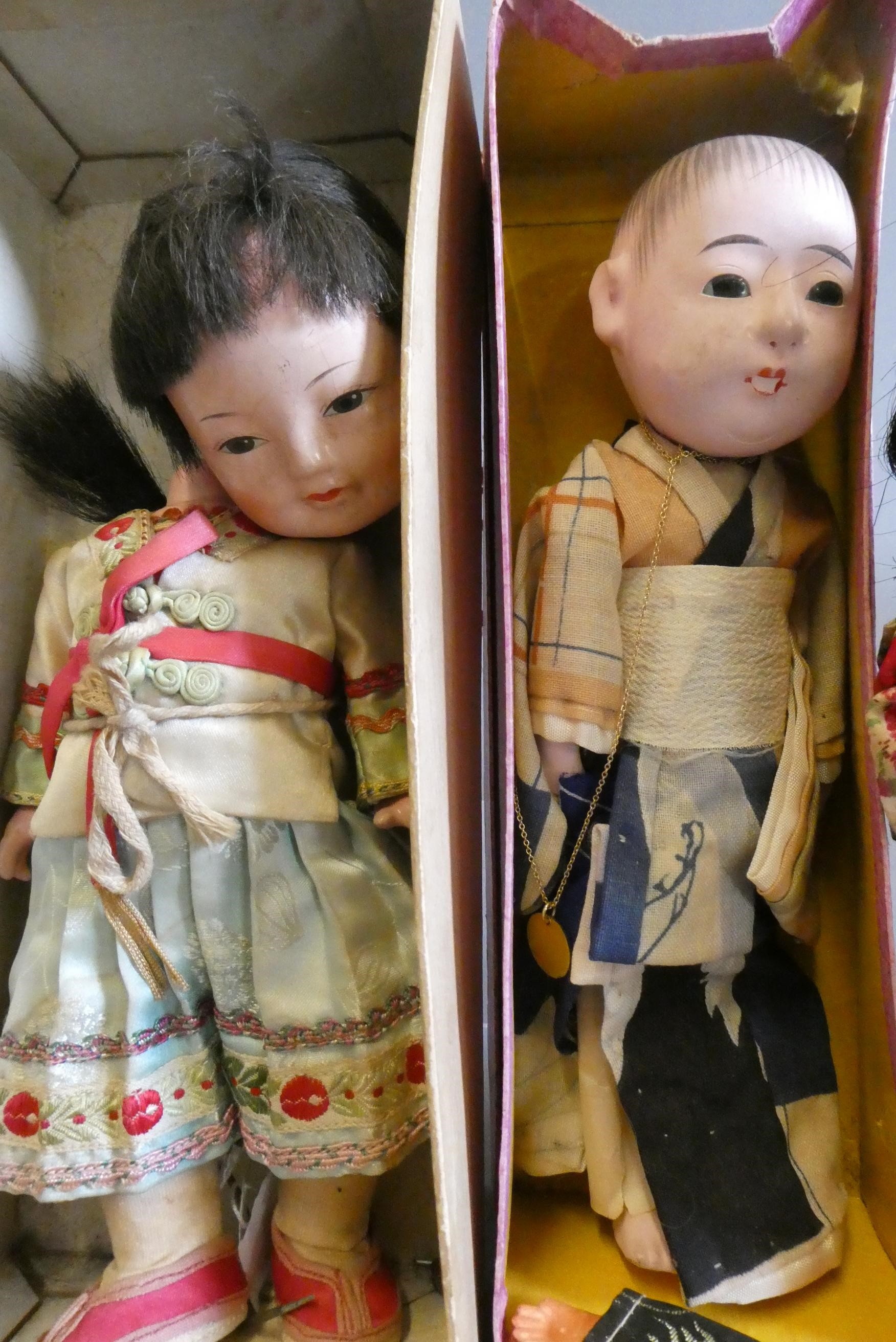 Five oriental dolls, including an 8" composition boy in original box, two bisque dolls and two Image