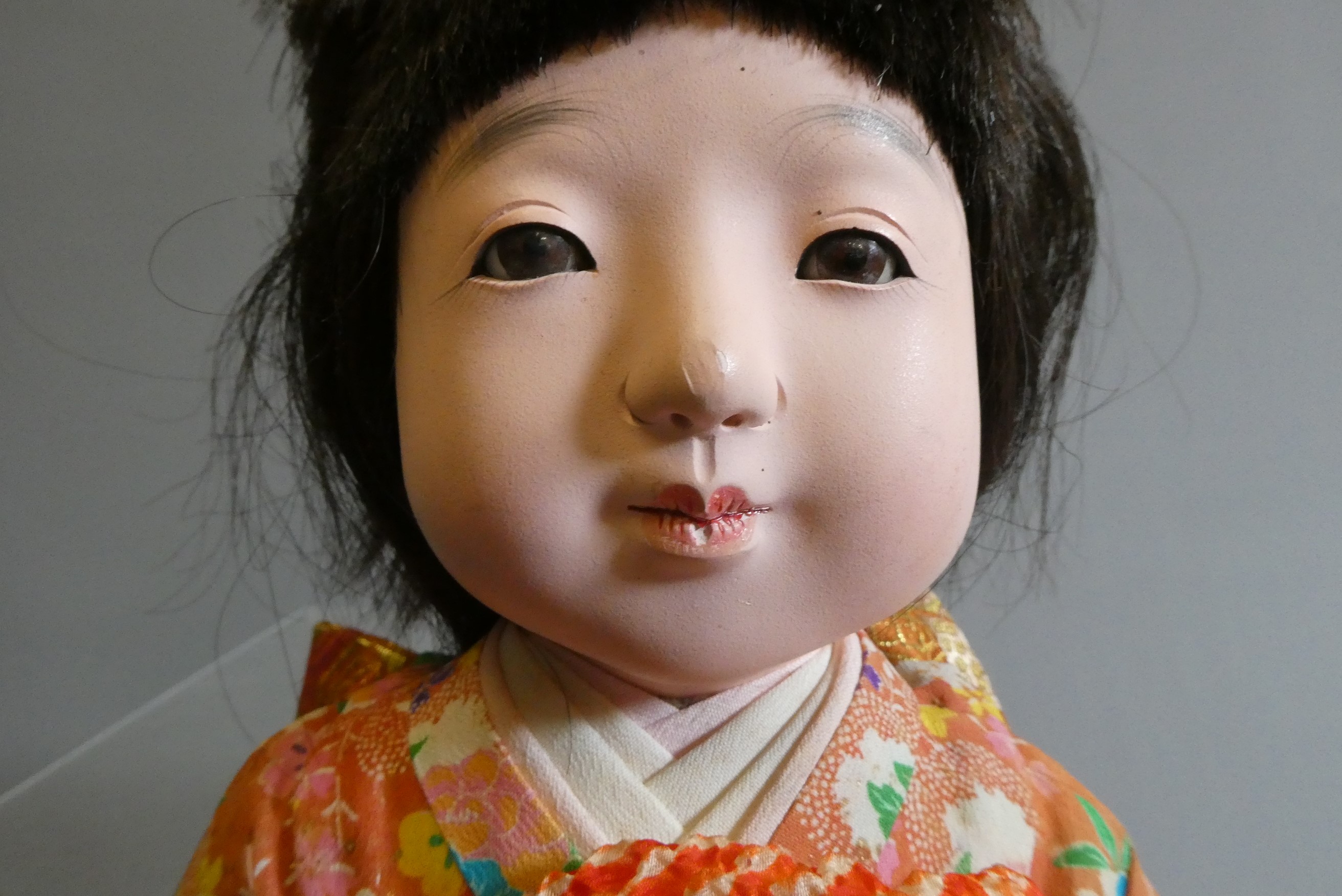 Two oriental dolls comprising an 11" bisque flange neck boy with sleeping eyes Image
