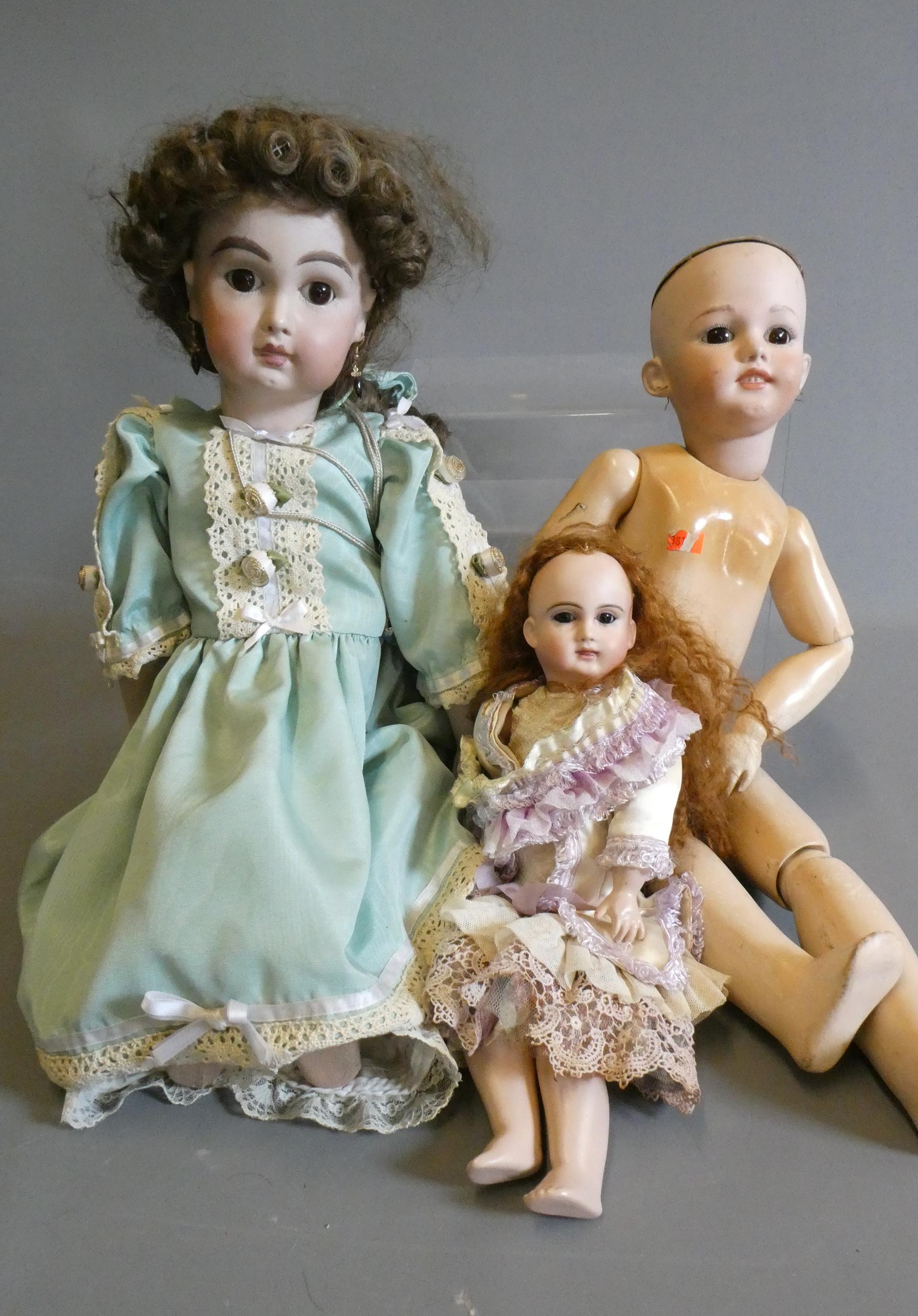 Three reproduction dolls, comprising a Jumeau MY91 type doll, 23" long, a Simon & Halbig 1248 with Image