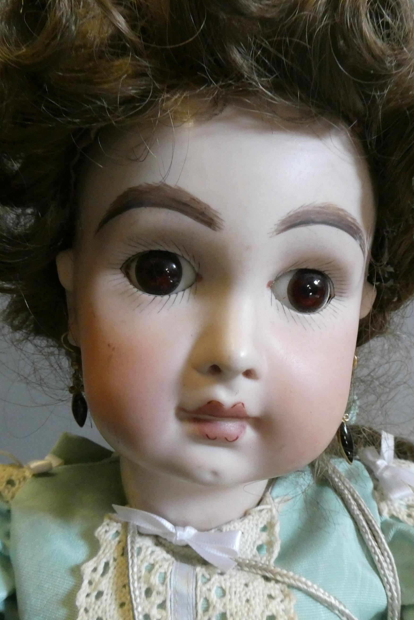 Three reproduction dolls, comprising a Jumeau MY91 type doll, 23" long, a Simon & Halbig 1248 with Image