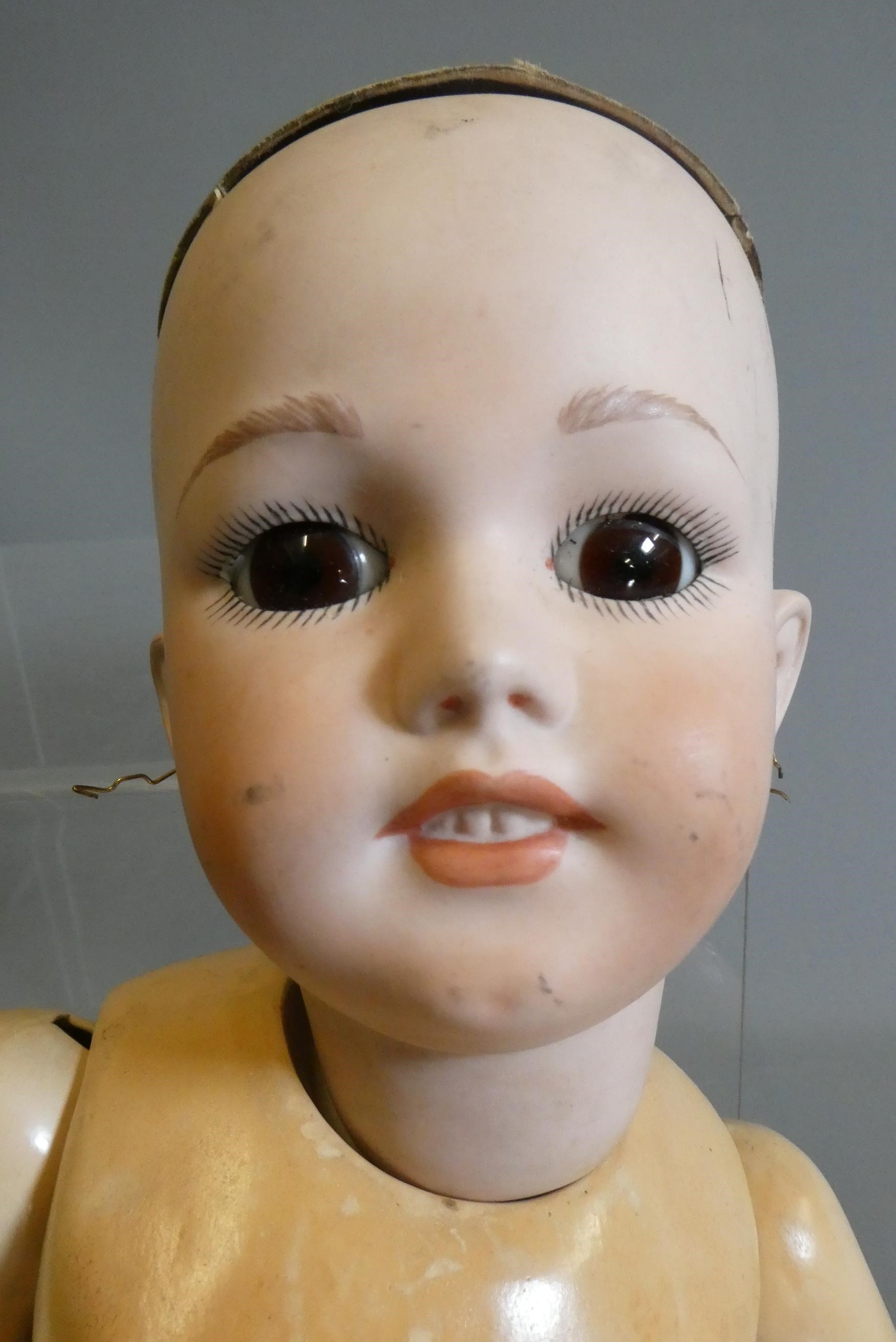 Three reproduction dolls, comprising a Jumeau MY91 type doll, 23" long, a Simon & Halbig 1248 with Image