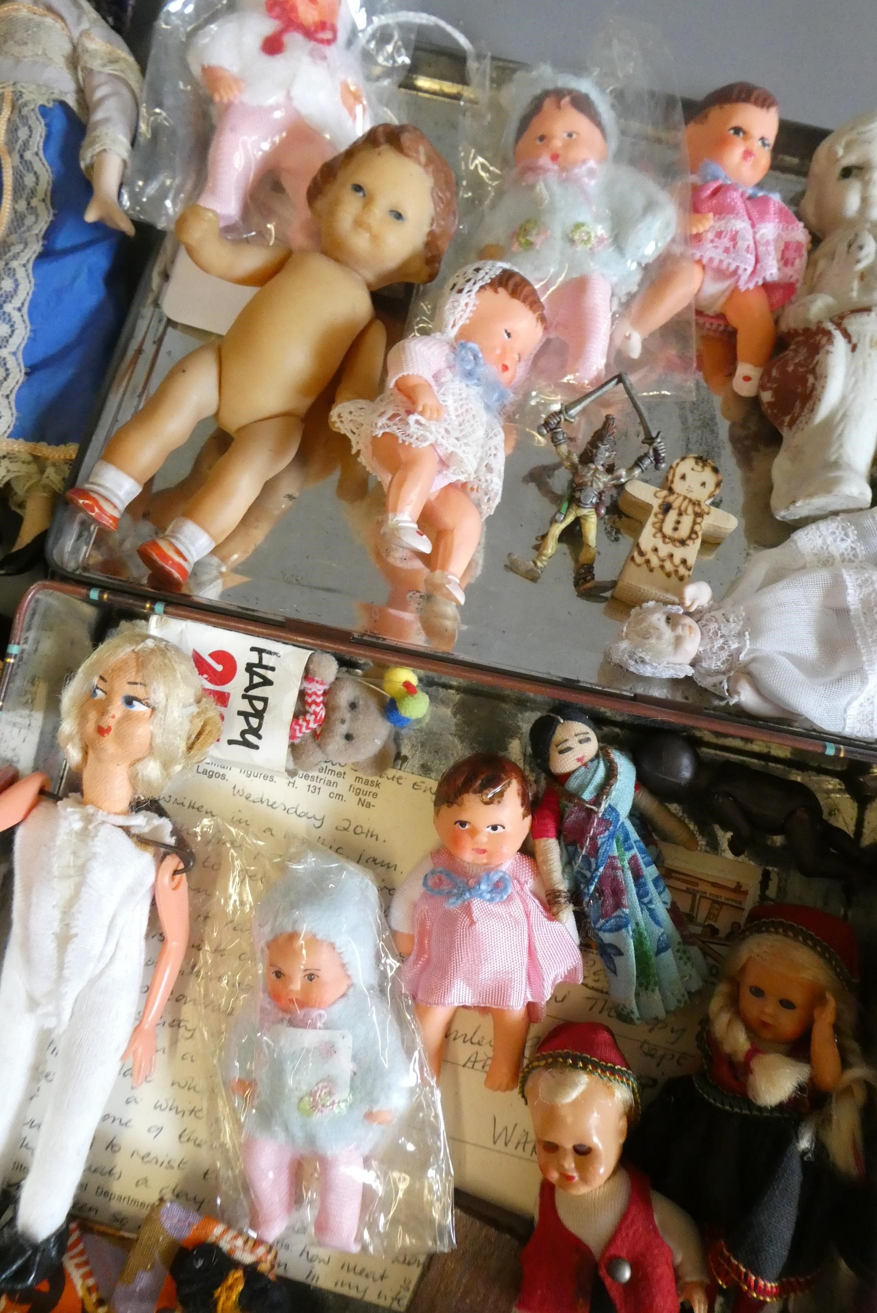 A collection of vintage and antique small dolls, including a Victorian peg doll, three bisque doll's Image