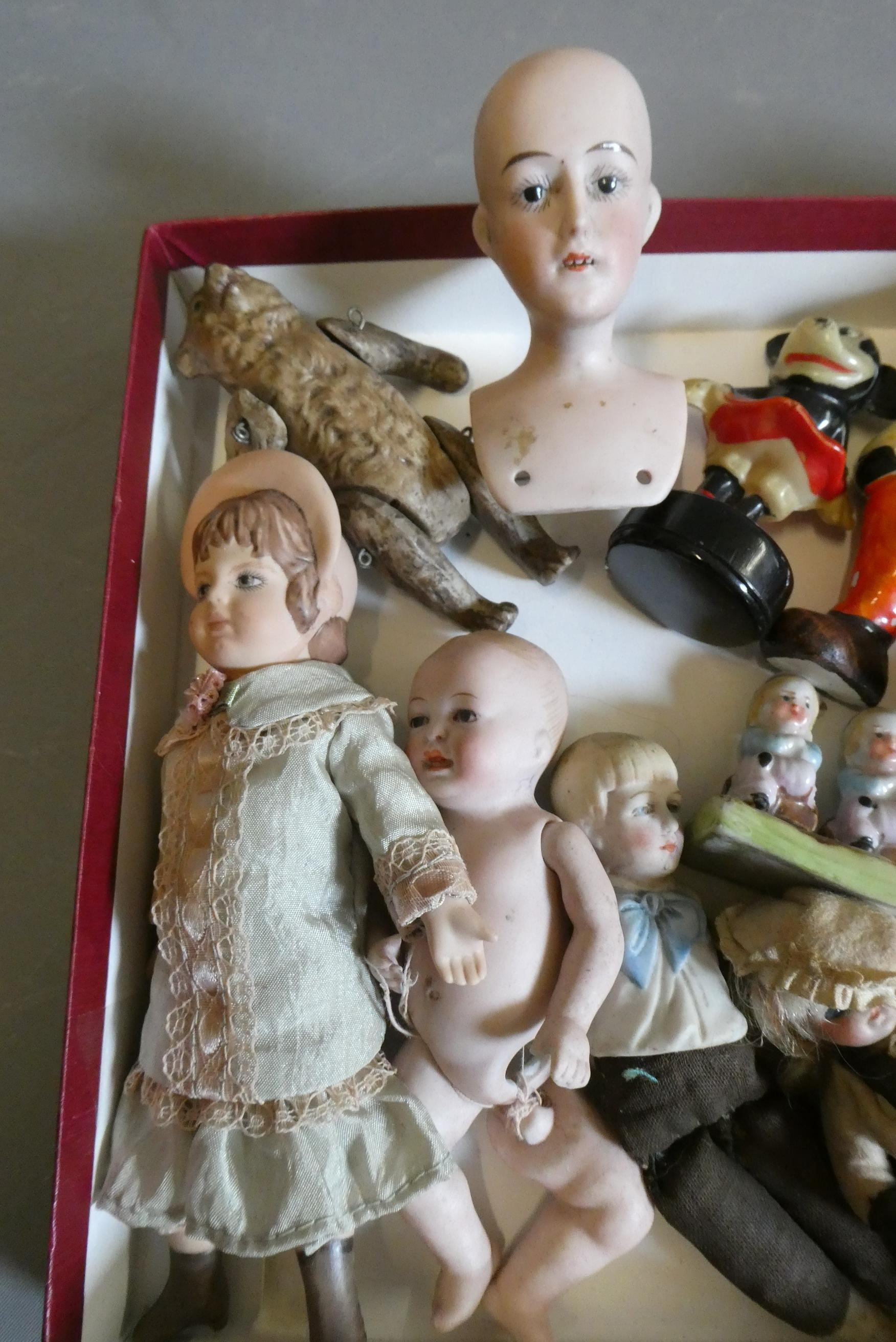 A collection of vintage and antique dolls and toys, including all bisque examples, an all bisque Image