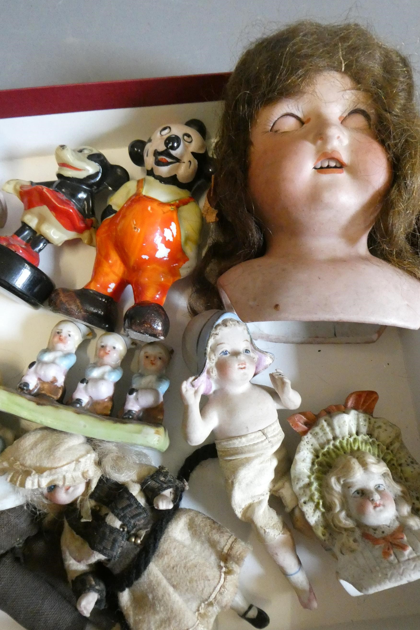 A collection of vintage and antique dolls and toys, including all bisque examples, an all bisque Image