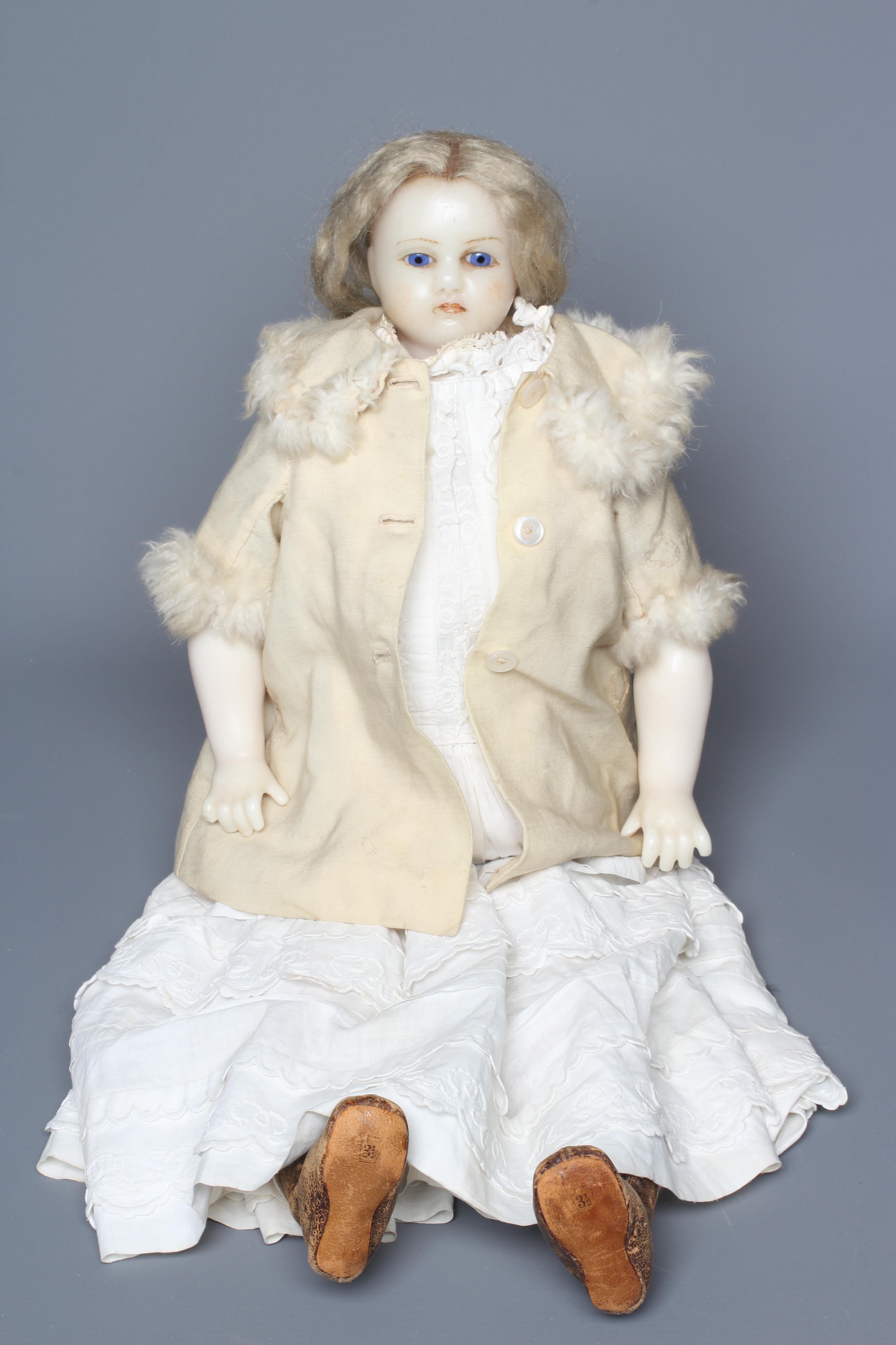 A Victorian poured wax shoulder head doll, with blue glass fixed eyes, closed mouth, blond wig, Image