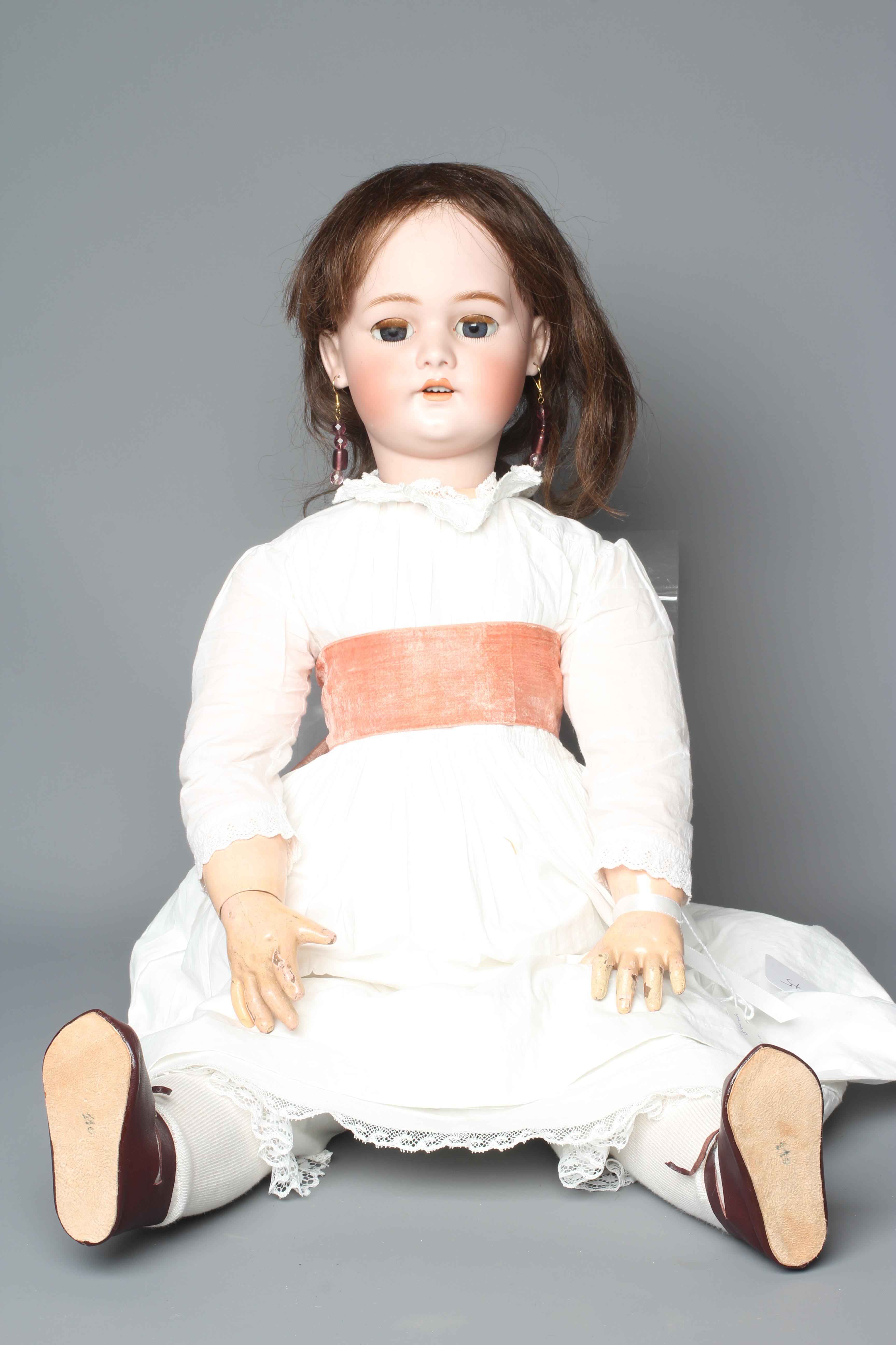 A Simon & Halbig bisque socket head doll, with blue glass sleeping eyes, open mouth, teeth, pierced Image