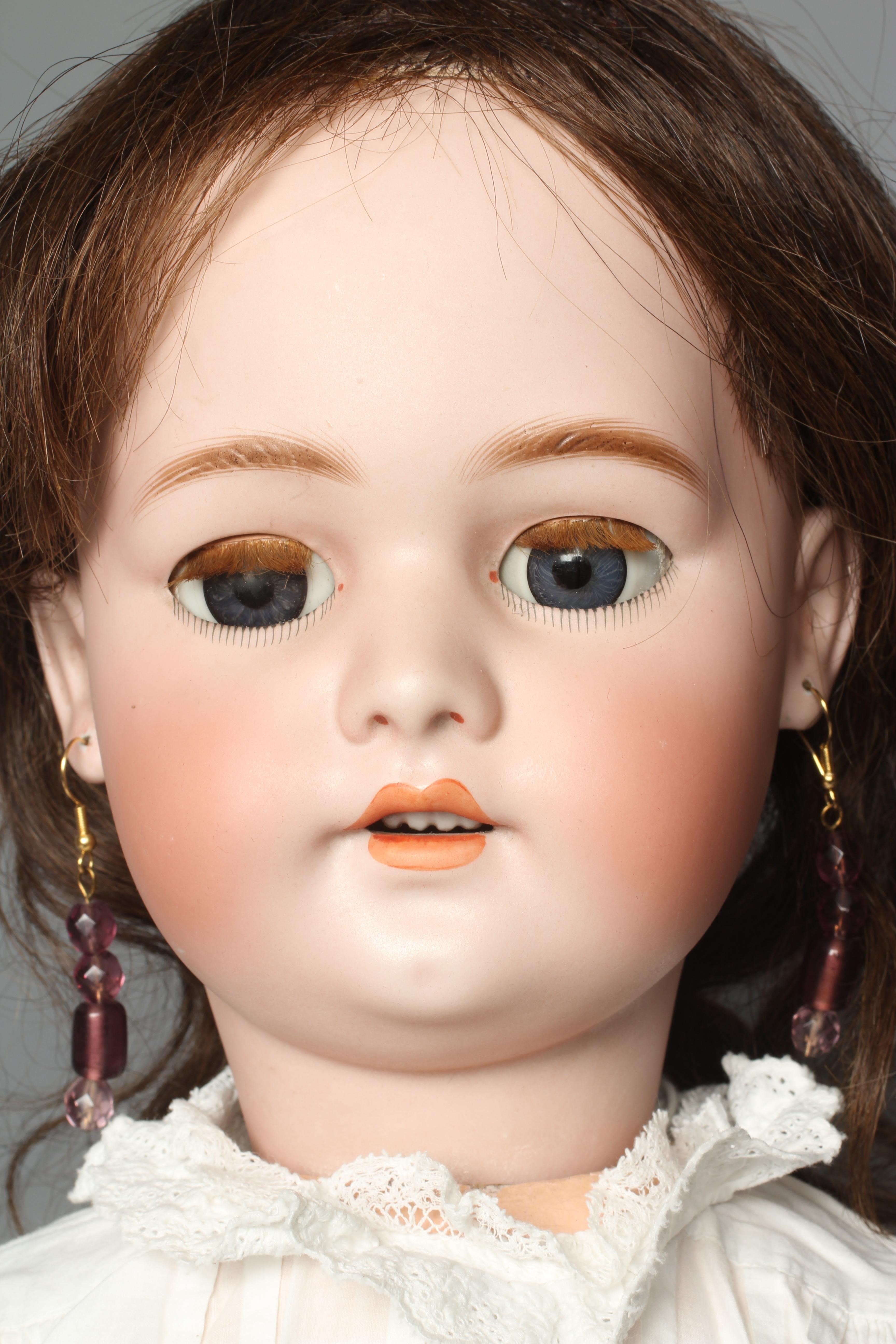 A Simon & Halbig bisque socket head doll, with blue glass sleeping eyes, open mouth, teeth, pierced Image