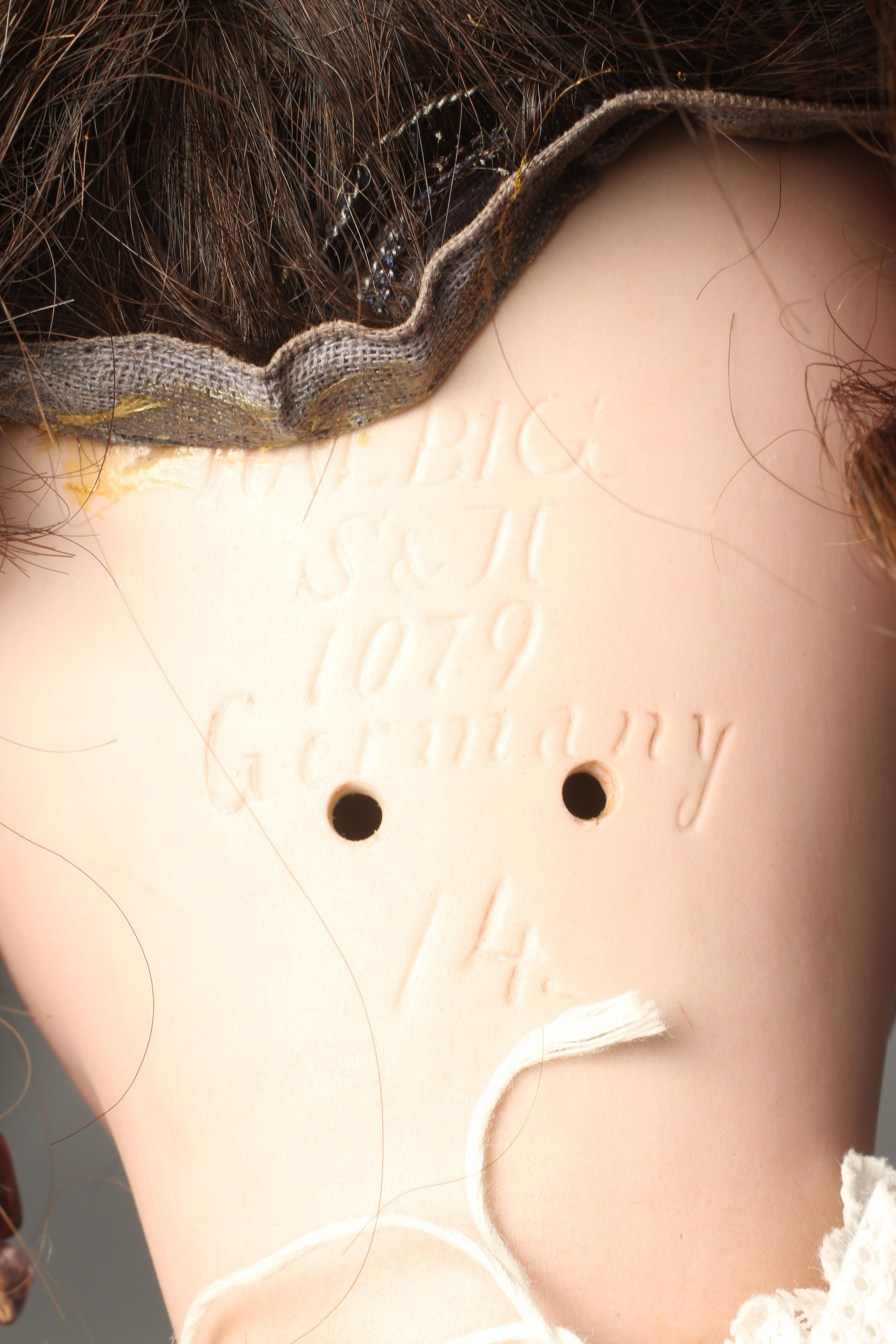 A Simon & Halbig bisque socket head doll, with blue glass sleeping eyes, open mouth, teeth, pierced Image
