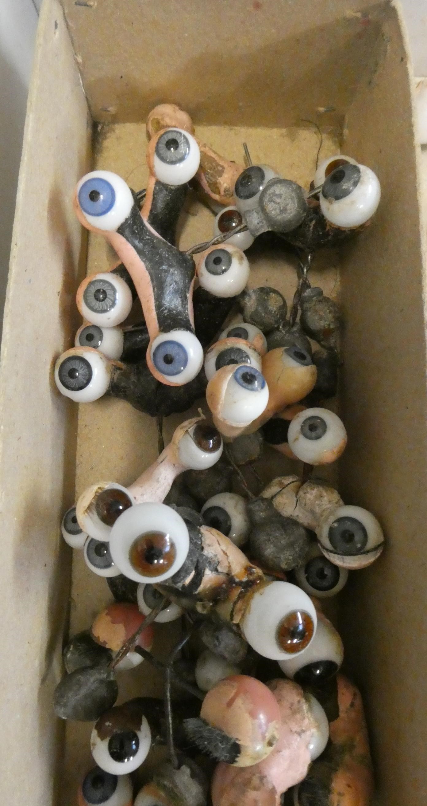 Twenty five pairs of doll's eyes on rockers, and other assorted eyes Image