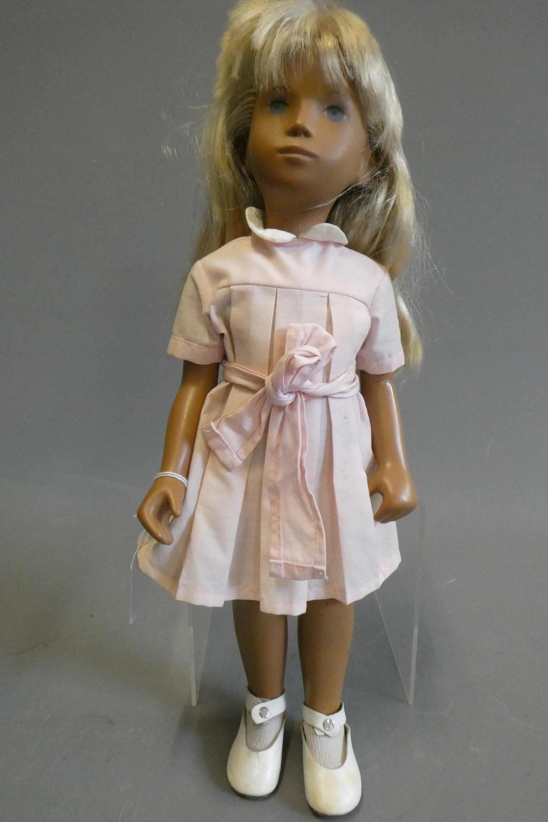 A Sasha girl doll, with blond hair, jointed body and pink dress, 16" tall Image