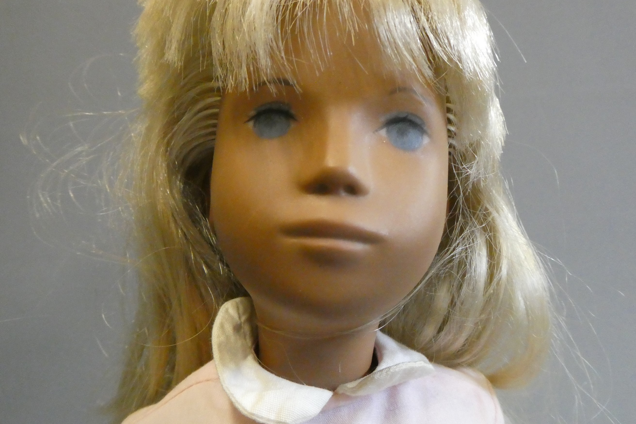 A Sasha girl doll, with blond hair, jointed body and pink dress, 16" tall Image