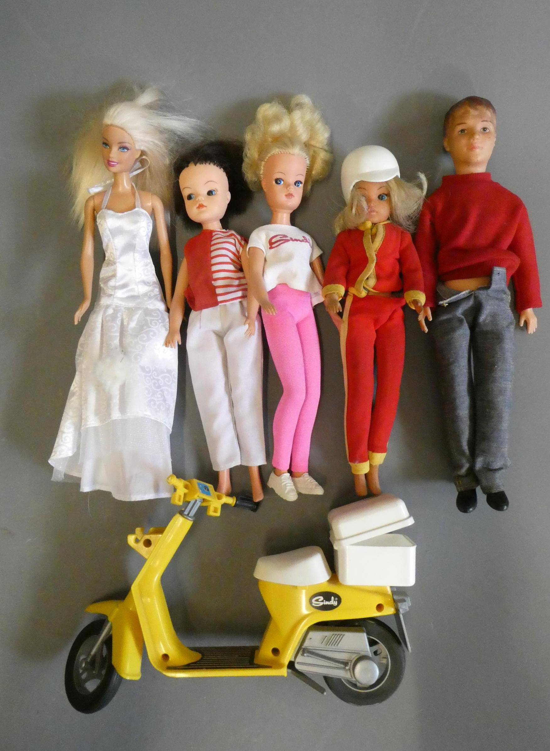 Vintage dolls comprising three Sindy dolls (one with scooter), a Pedigree Sindy Paul doll, and a Image