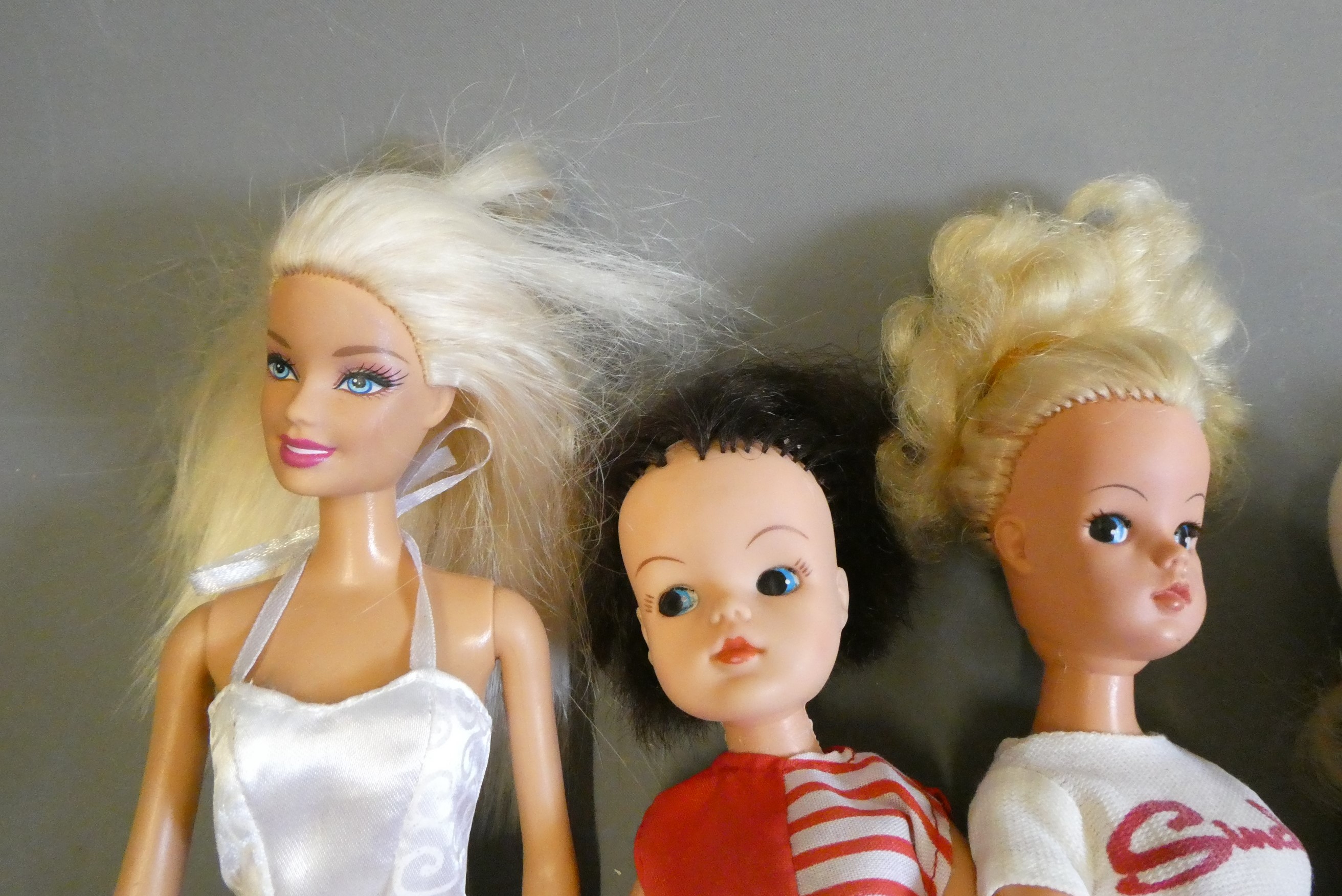 Vintage dolls comprising three Sindy dolls (one with scooter), a Pedigree Sindy Paul doll, and a Image
